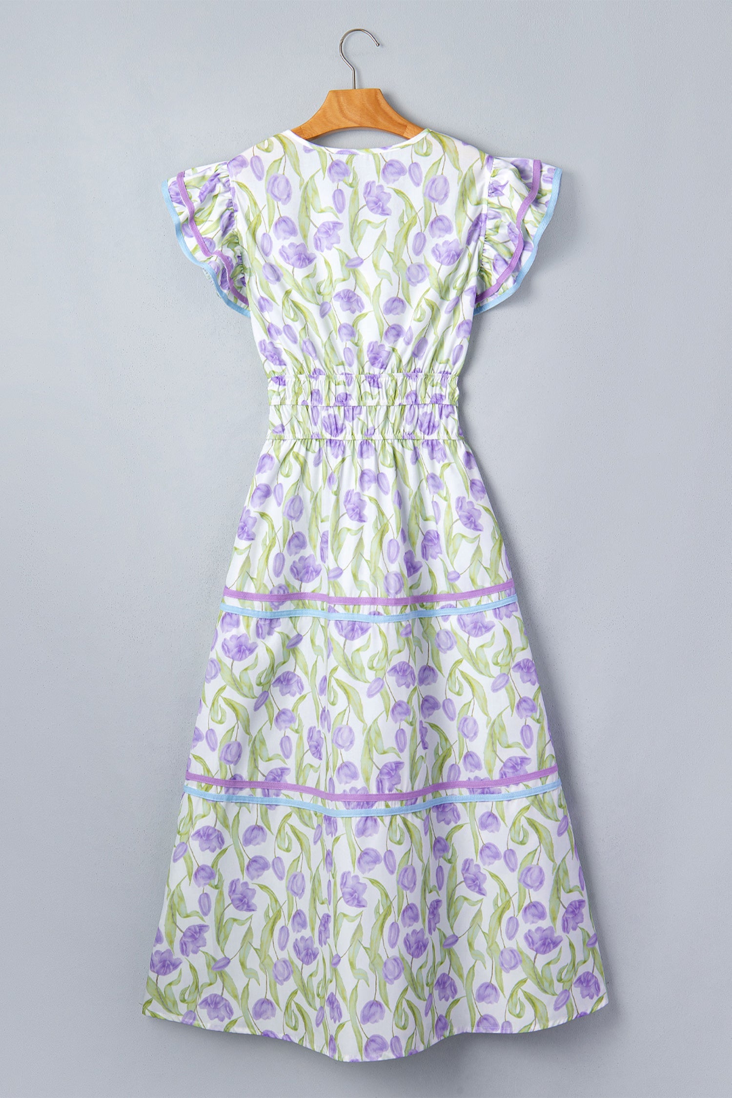 Floral Tulip Contrast Trim Midi Dress in Purple with floral print, colorblock contrast trim, flutter sleeves, and relaxed shift silhouette shown on model