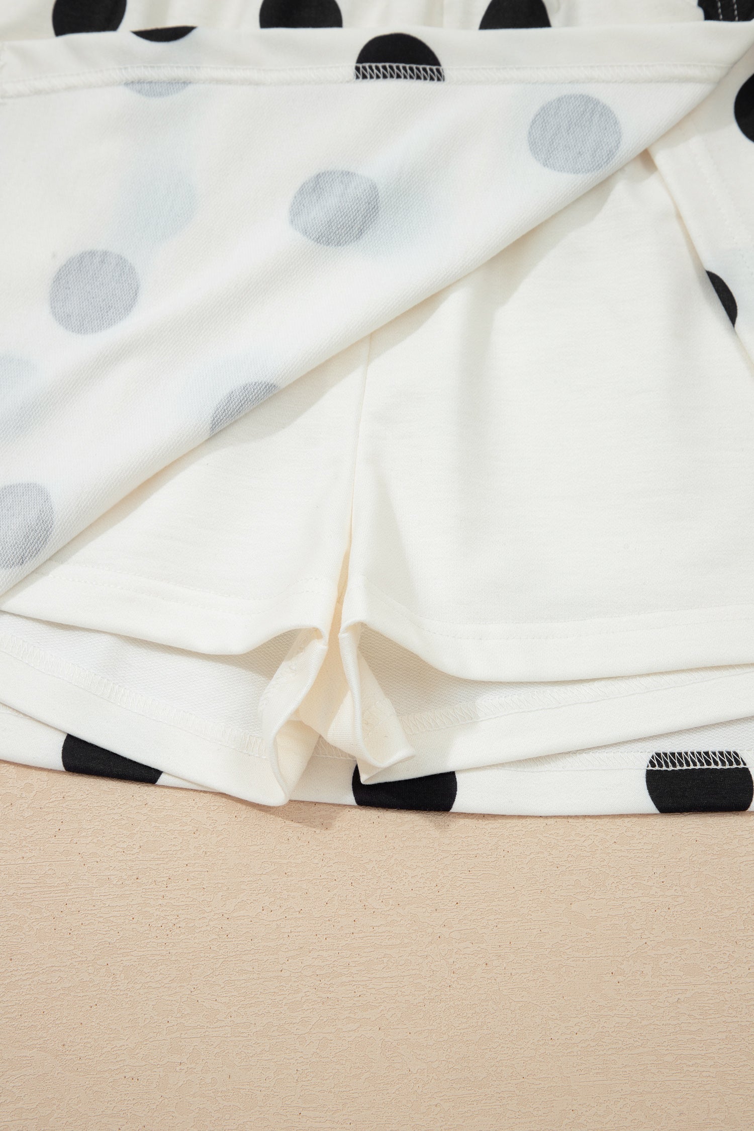 Polka Dot Ribbed Trim Tank and Mini Skort Set in White with polka dot print, ribbed trim tank top, and split mini skort shown on model