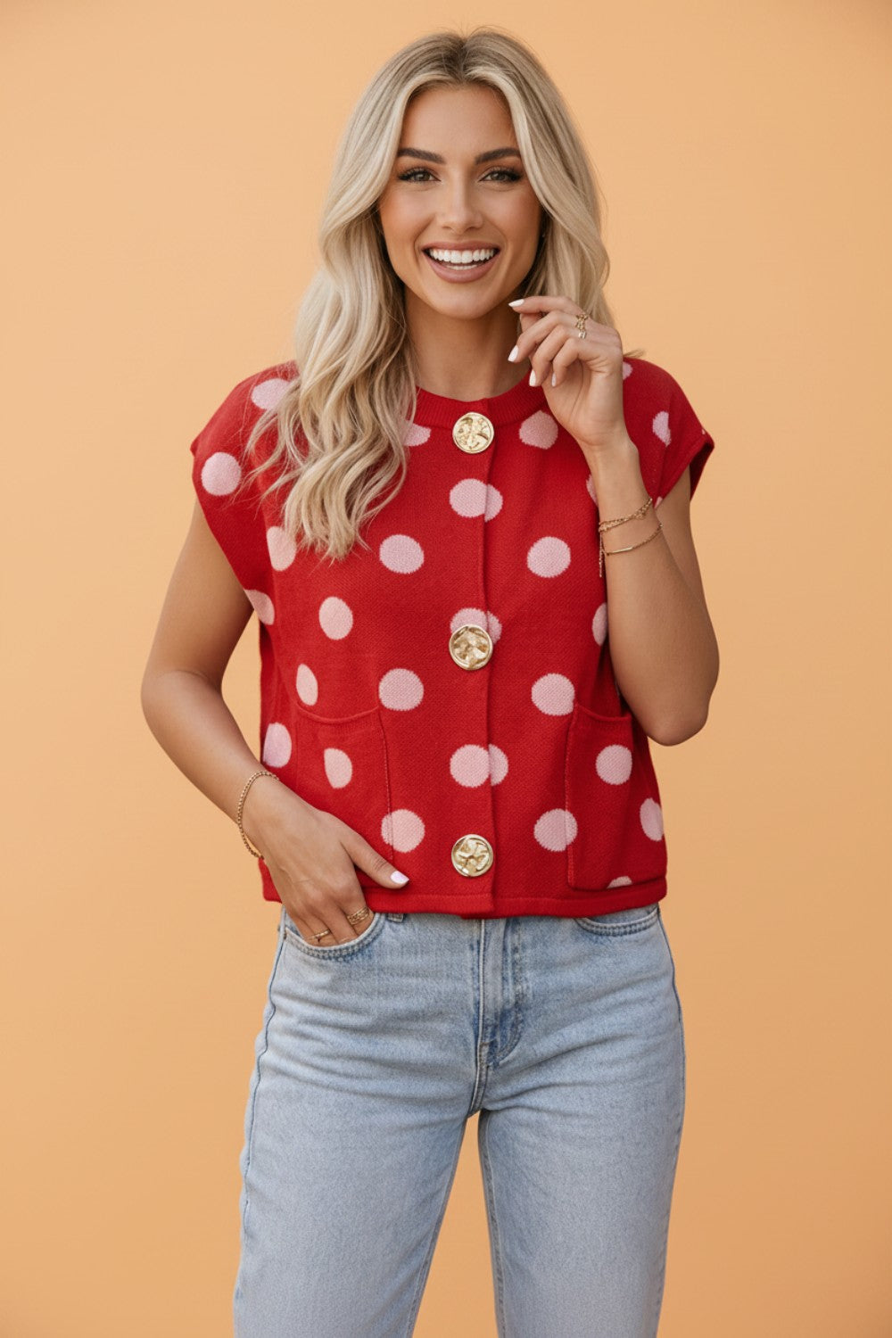 Red polka dot knit vest with button front and round neck