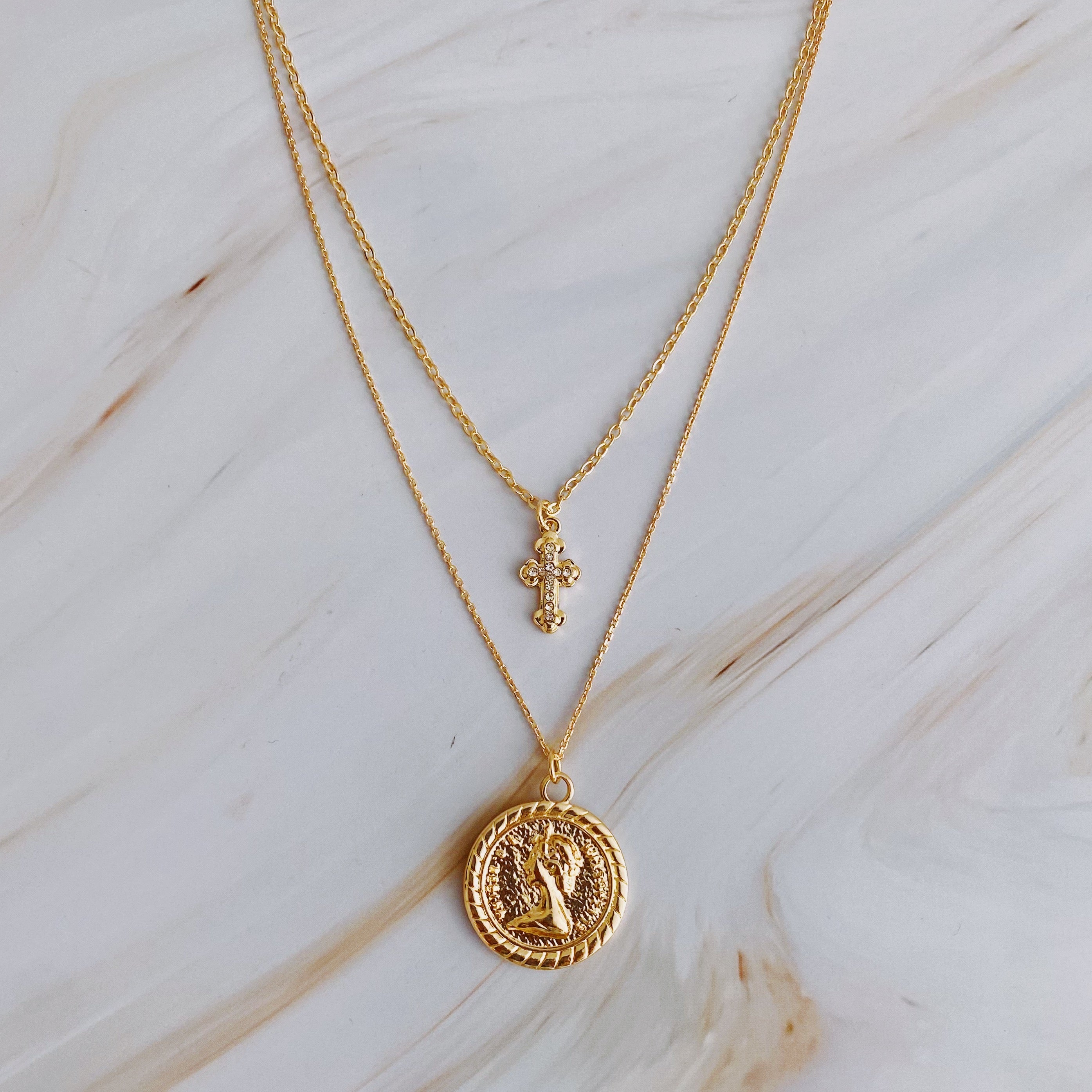 Cross And Coin Layered Necklace - close up of cross and coin pendants
