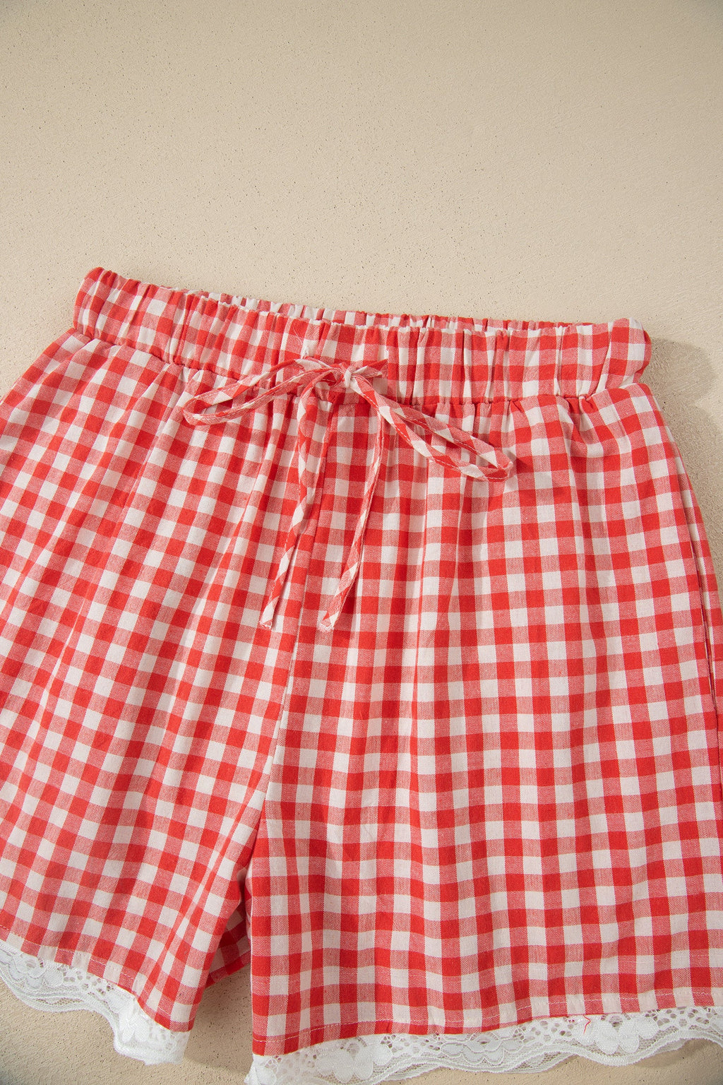 Gingham Plaid Tie Waist Lace Hem Shorts in Red with gingham print, front tie waist, and lace hem trim shown on model