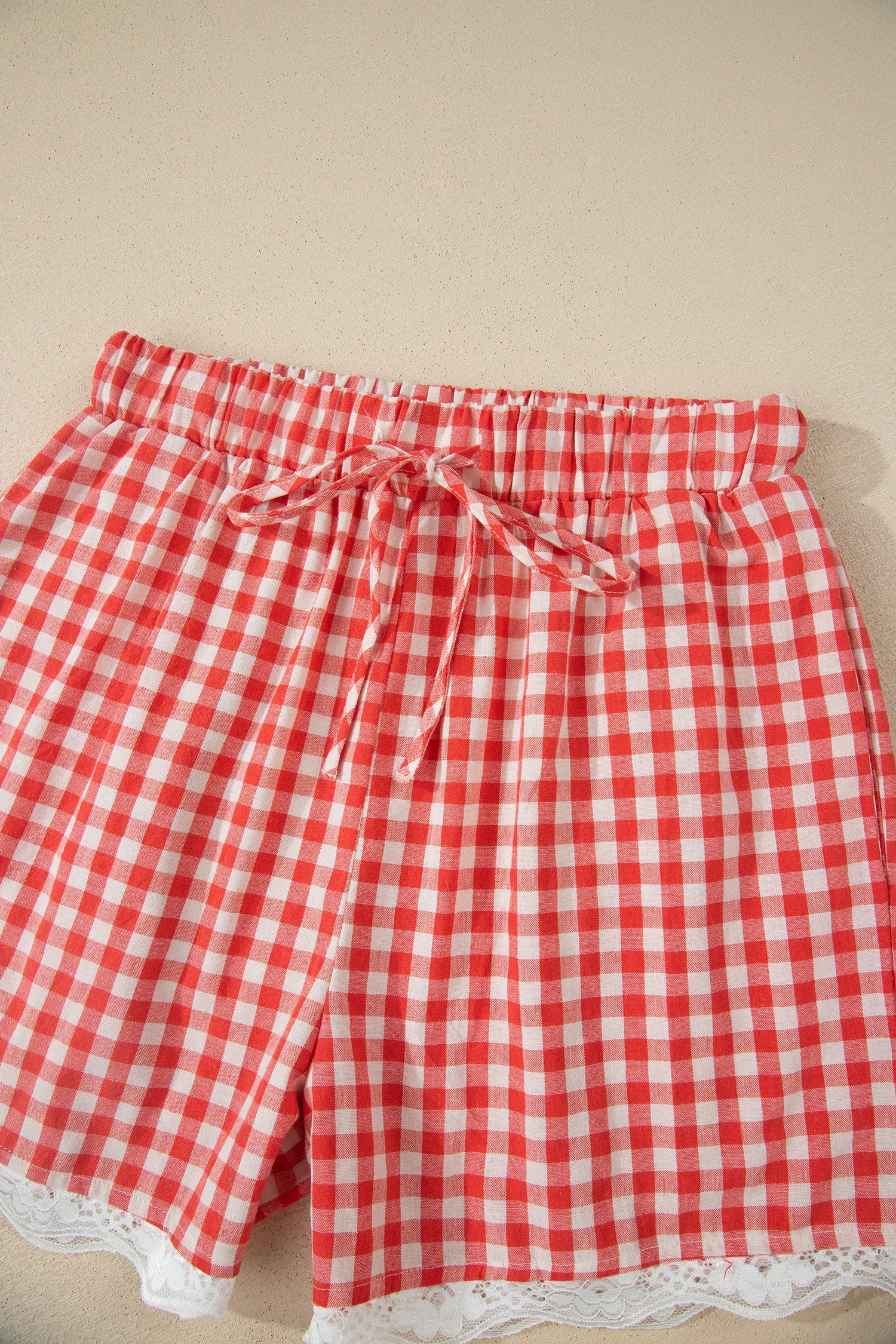 Gingham Plaid Tie Waist Lace Hem Shorts in Red with gingham print, front tie waist, and lace hem trim shown on model