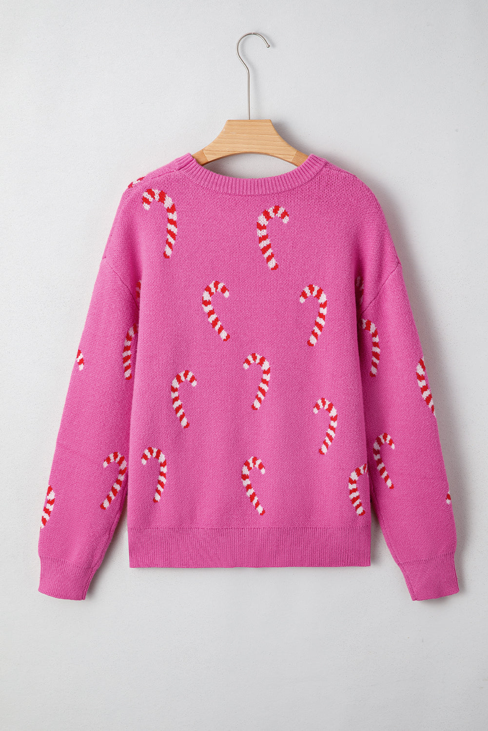 Christmas Candy Cane Drop Shoulder Sweater in dark green and sachet pink, lifestyle view