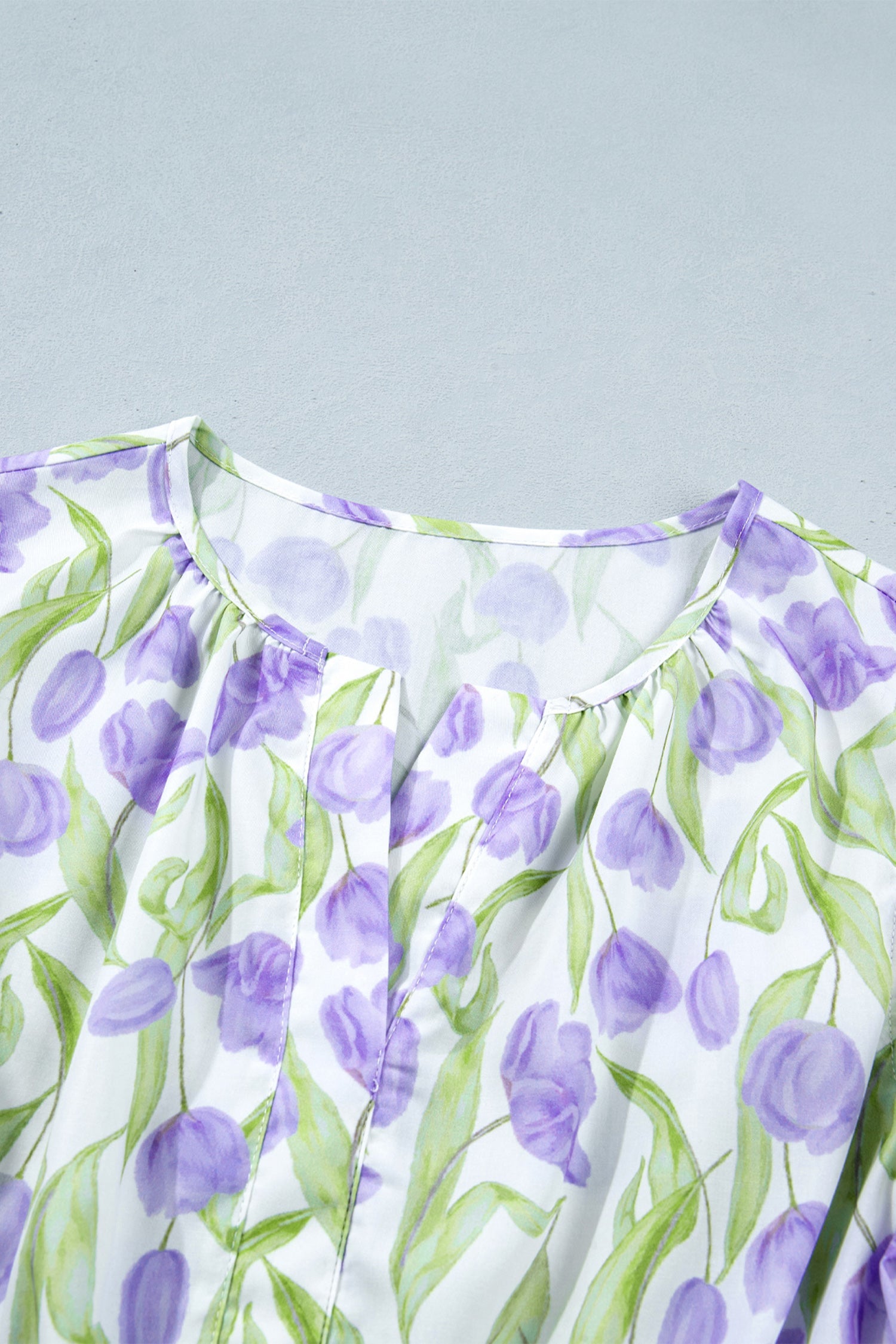 Floral Tulip Contrast Trim Midi Dress in Purple with floral print, colorblock contrast trim, flutter sleeves, and relaxed shift silhouette shown on model