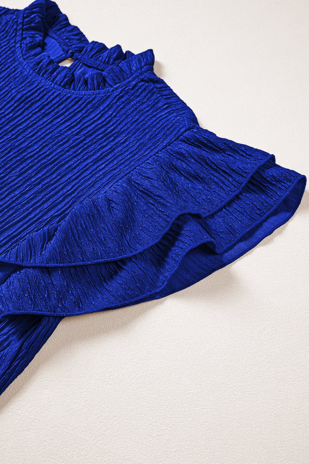 Solid Textured Ruffle Trim Short Sleeve Blouse - close up of textured fabric and ruffle trim detail
