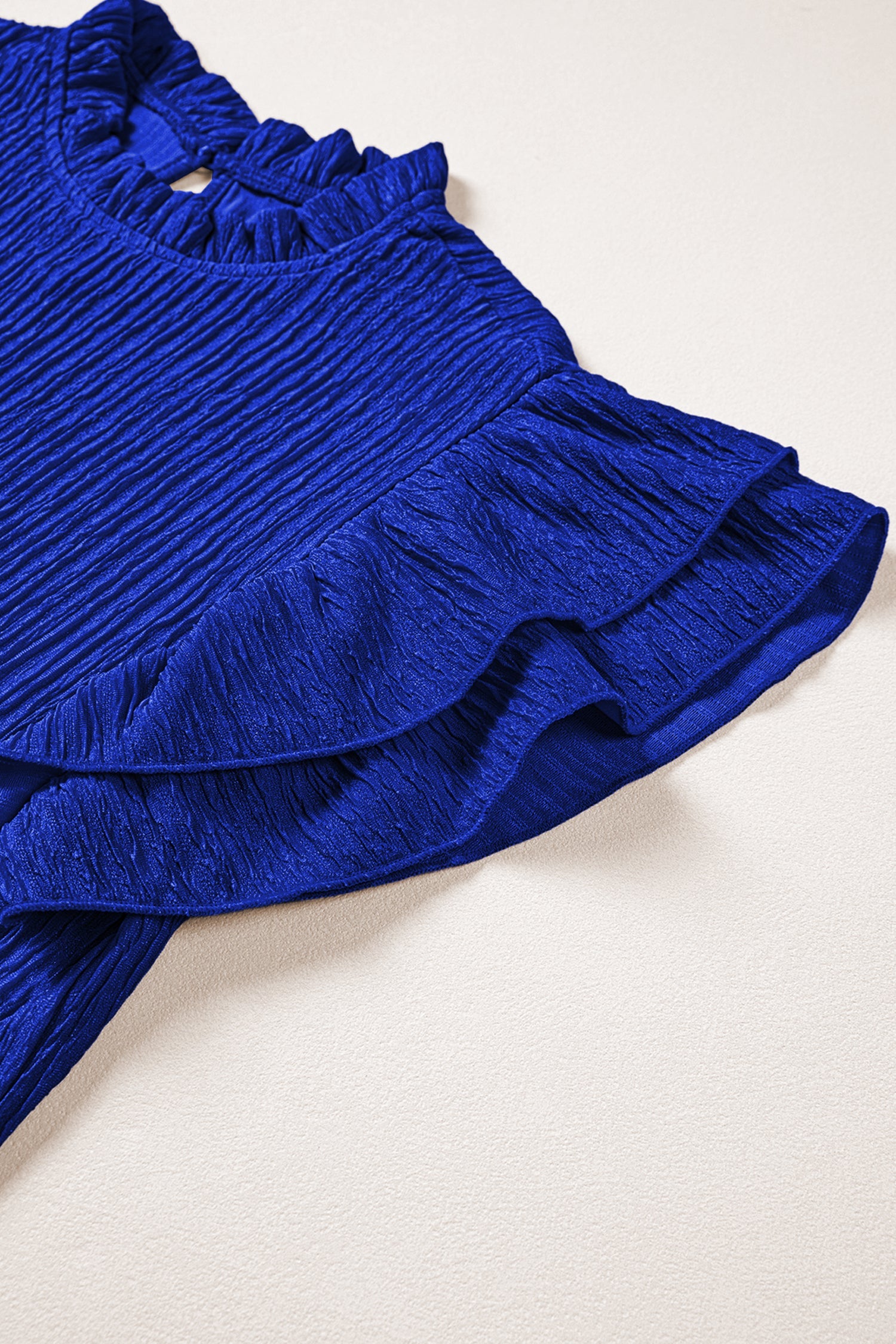 Solid Textured Ruffle Trim Short Sleeve Blouse - close up of textured fabric and ruffle trim detail