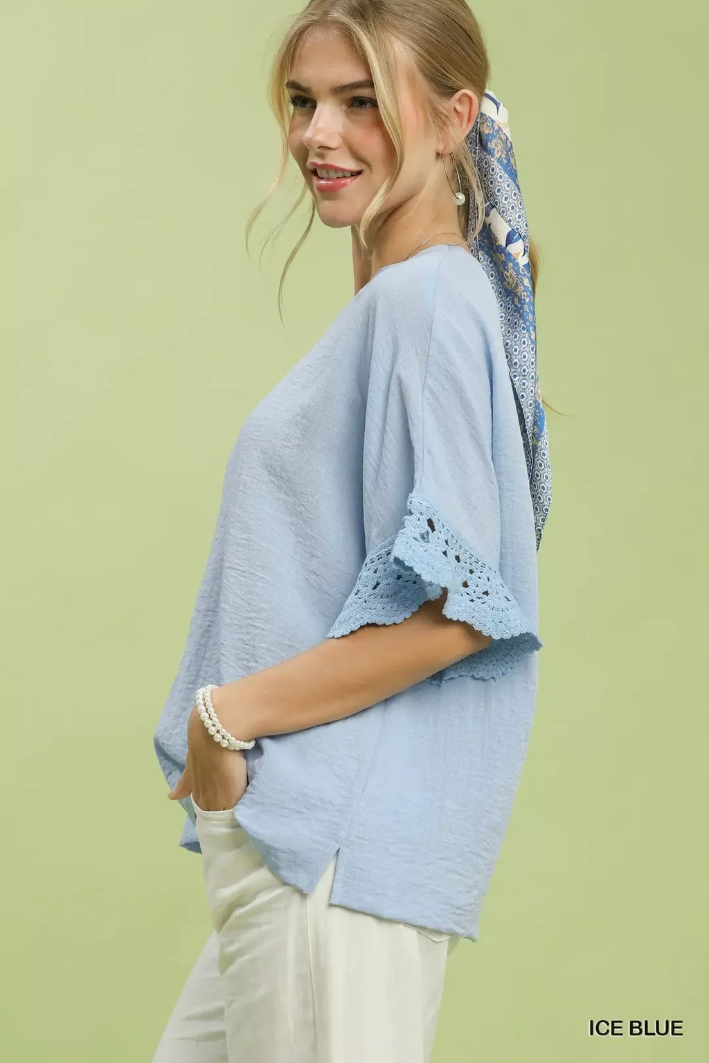 Umgee Crochet Trim Flutter Sleeve Top in Ice Blue - back view showing hi-low hem