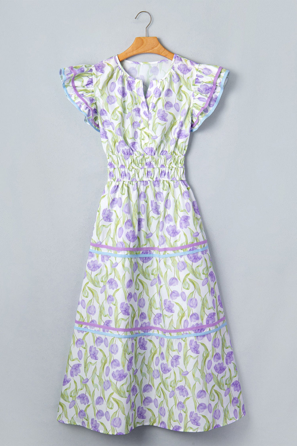 Floral Tulip Contrast Trim Midi Dress in Purple with floral print, colorblock contrast trim, flutter sleeves, and relaxed shift silhouette shown on model