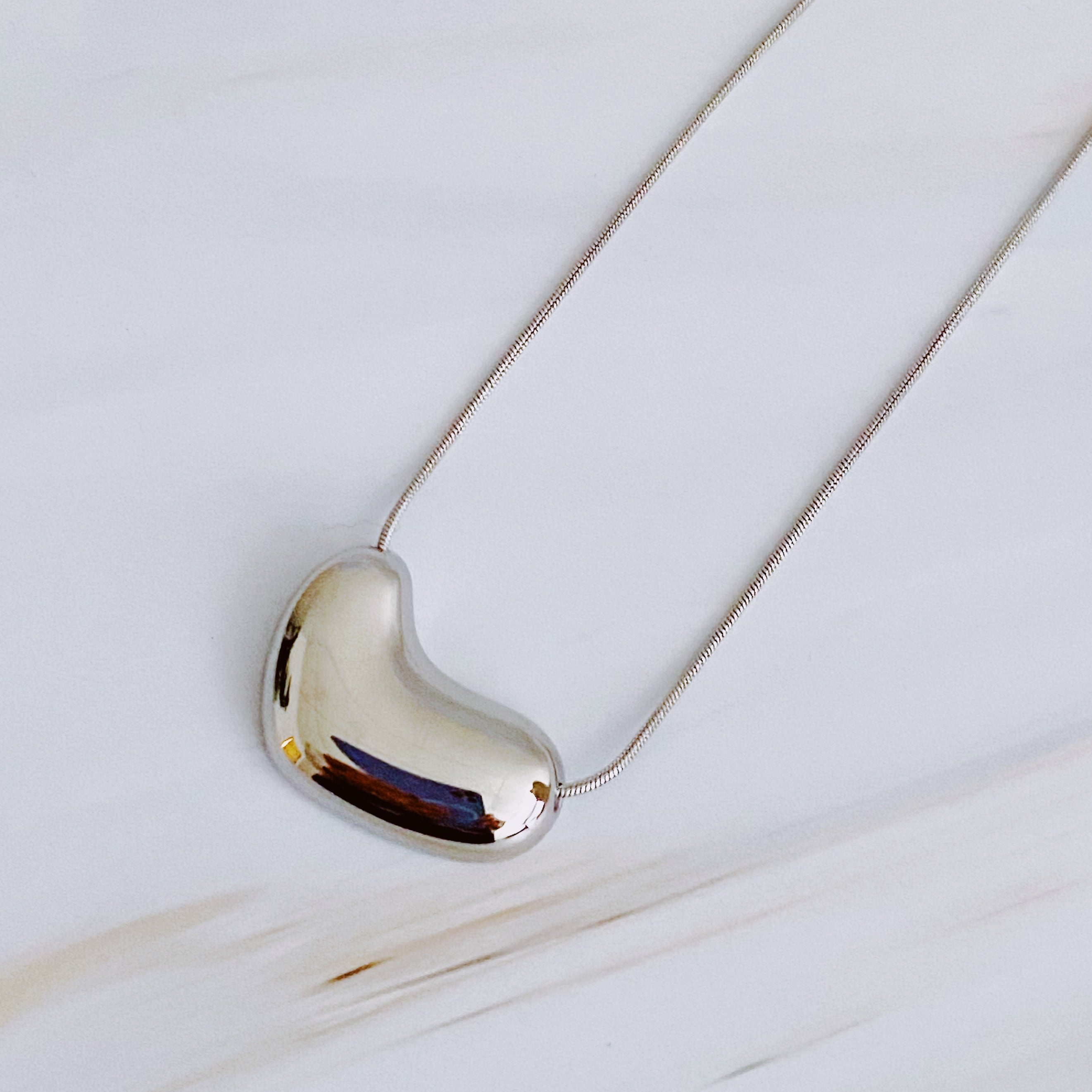 Bold Molten Heart Necklace - close up of molten heart texture