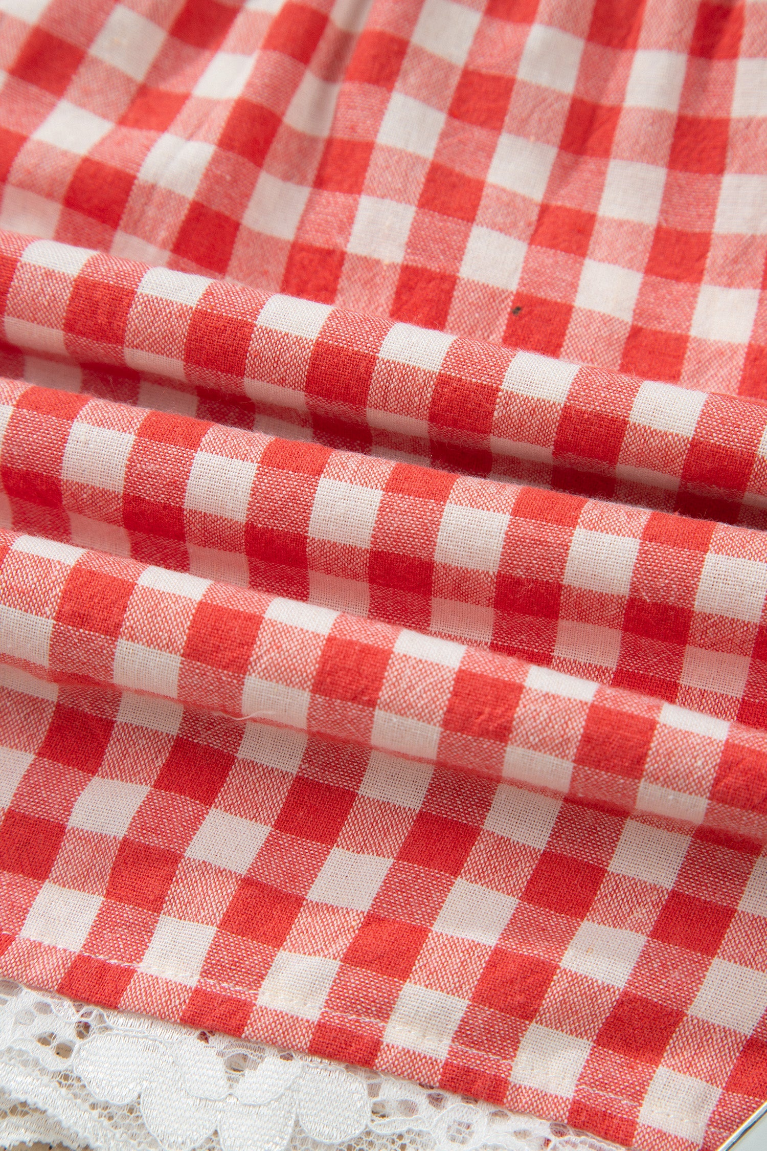 Gingham Plaid Tie Waist Lace Hem Shorts in Red with gingham print, front tie waist, and lace hem trim shown on model