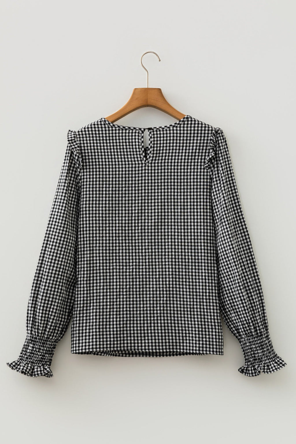 Black gingham blouse shirred cuff close-up