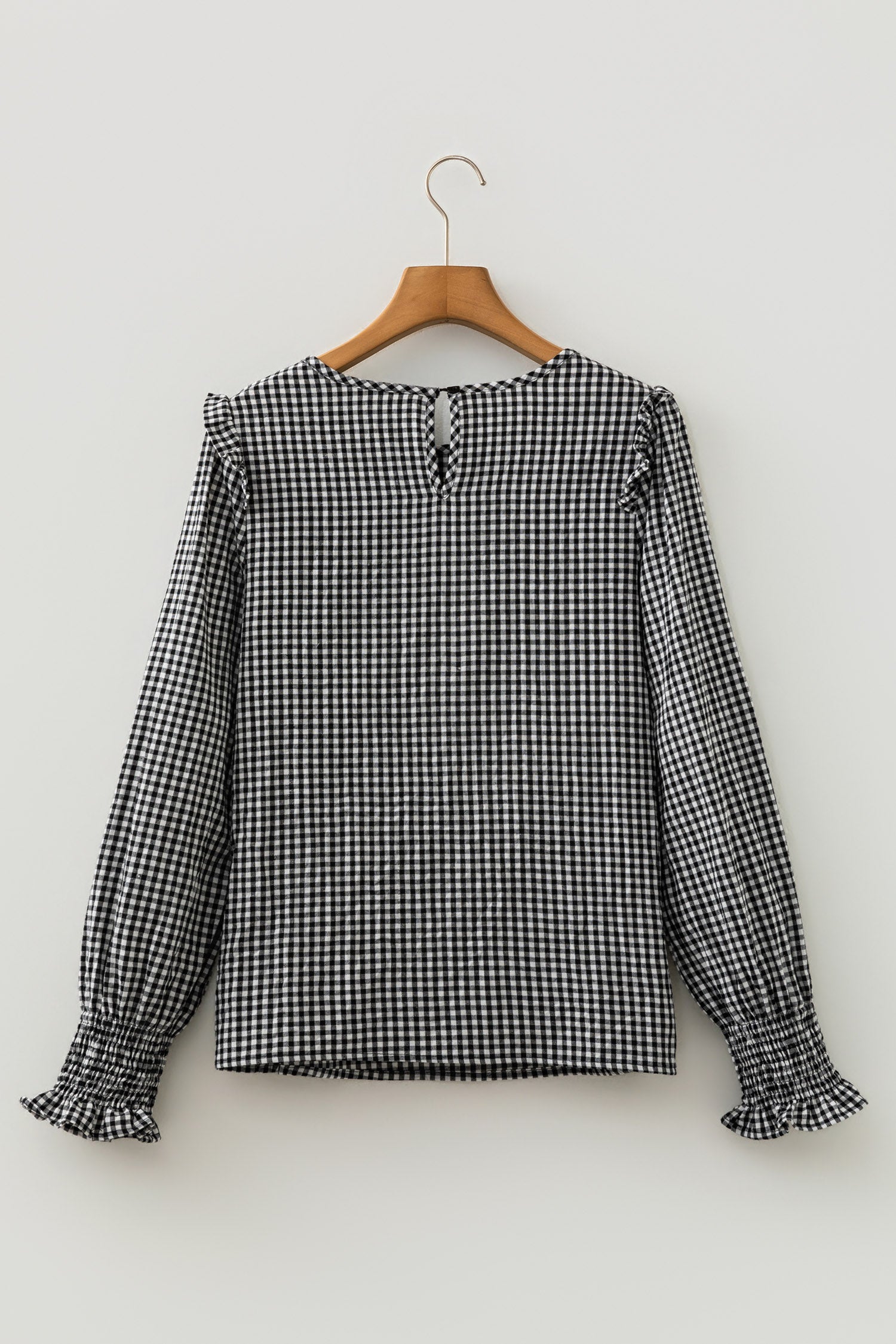 Black gingham blouse shirred cuff close-up