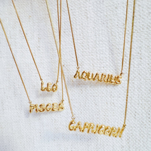 Balloon Letter Zodiac Necklace - multiple zodiac signs flat lay