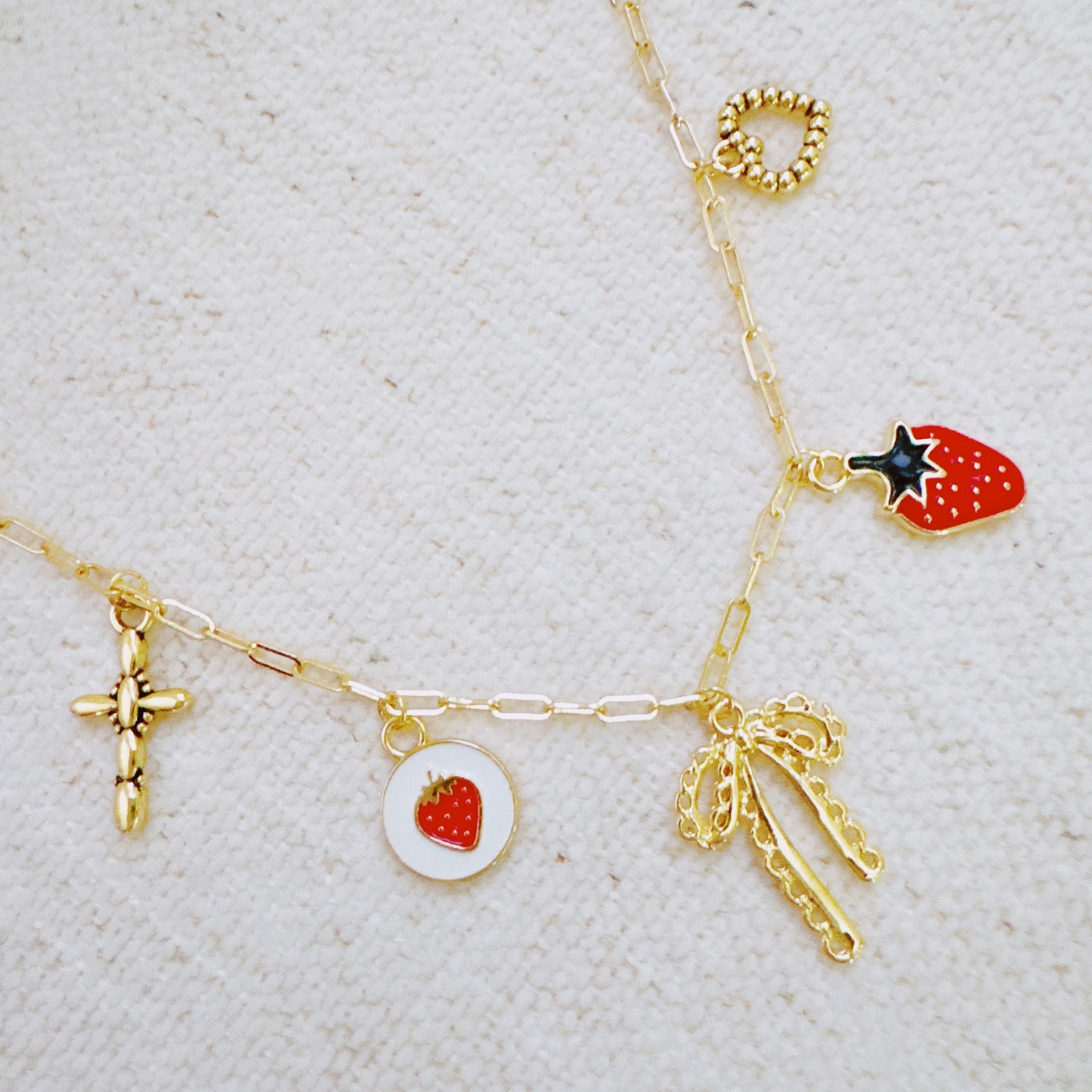 Berry Cute Charm Bracelet with strawberry bow and heart charms - gold tone