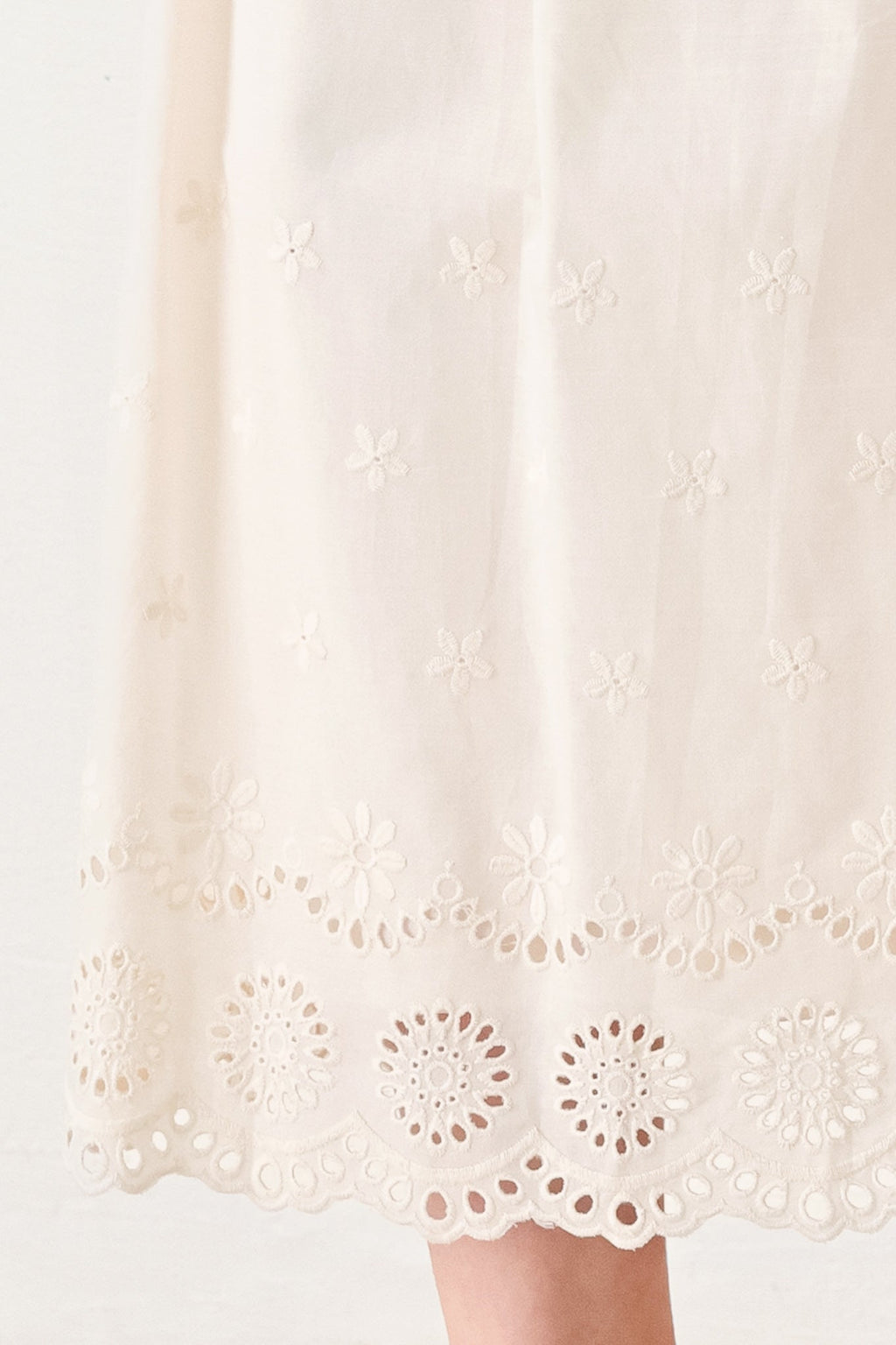 Daydream Thread Midi Dress in Light Taupe with sweater knit top, round neckline, sleeveless cut, drop waist, woven eyelet skirt, and cut out at waist shown on model