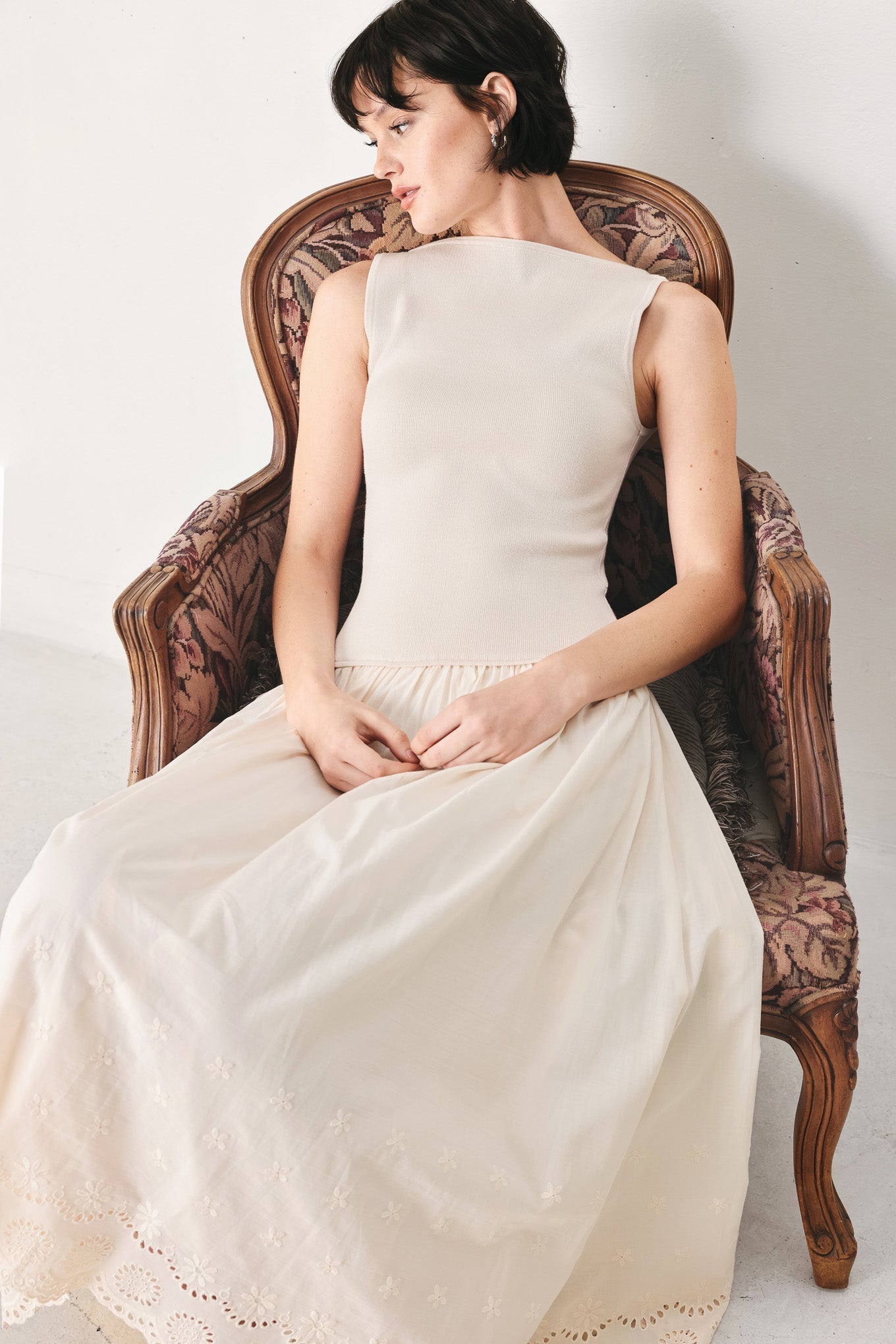 Daydream Thread Midi Dress in Light Taupe with sweater knit top, round neckline, sleeveless cut, drop waist, woven eyelet skirt, and cut out at waist shown on model