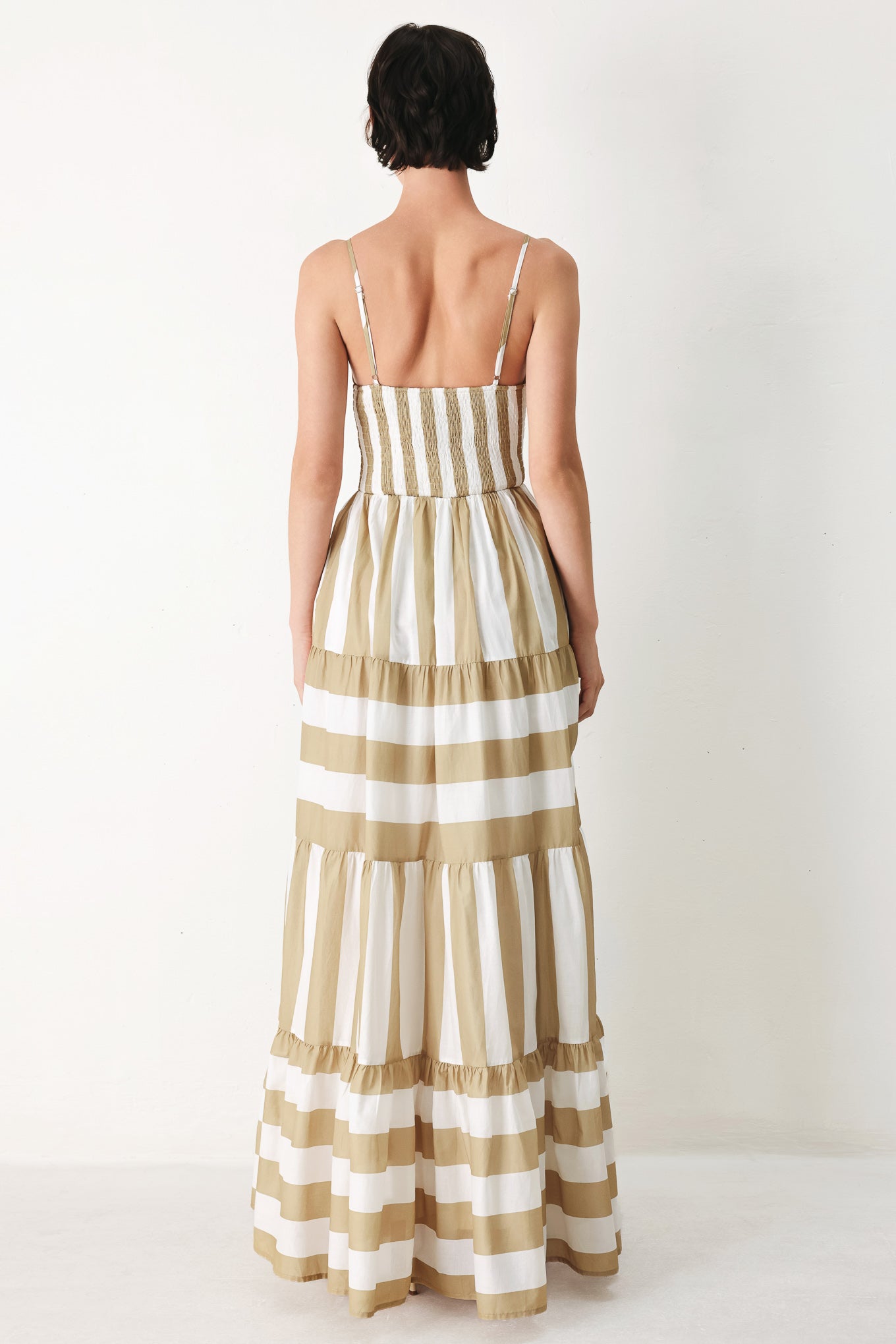 Sunkissed Boardwalk Woven Maxi Dress in Taupe White with stripe print, cami-style bodice, smocked back, and tiered skirt shown on model