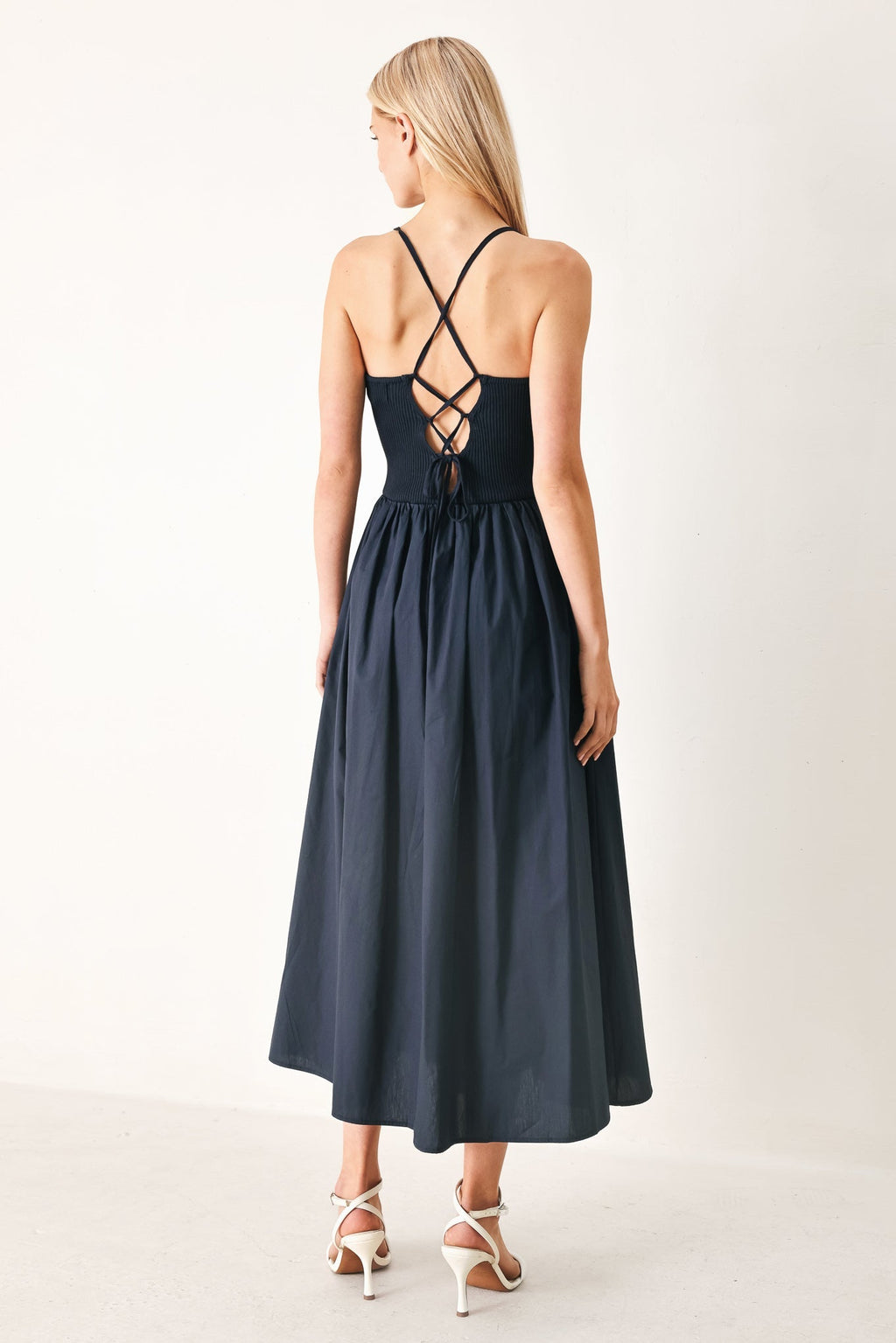 Easy Breeze Navy Woven Midi Dress with ribbed sweater knit tank top, solid woven skirt, bare back, and lace-up tie detail shown on model