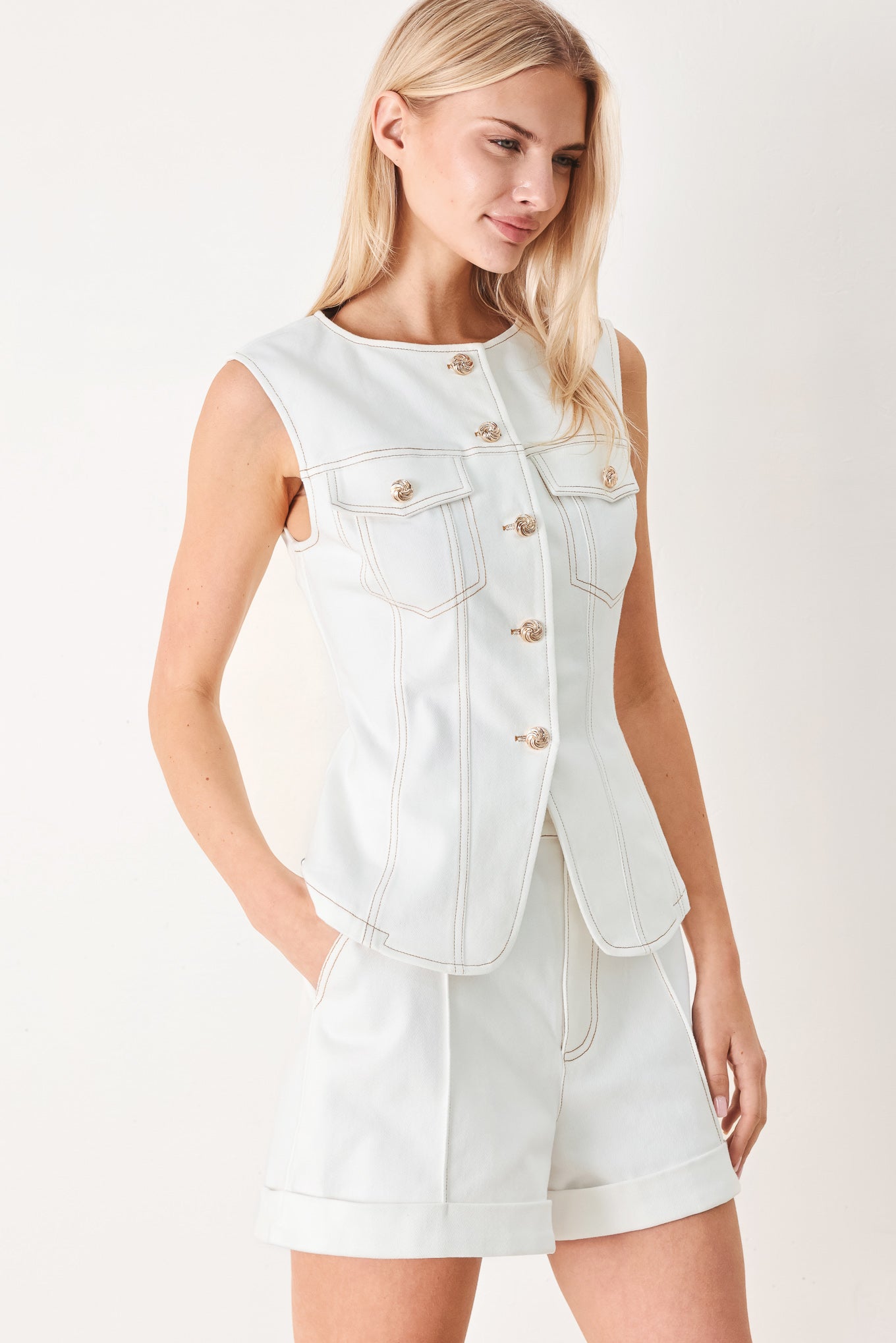 Better Together Woven Vest in White with round neckline, sleeveless cut, front closure, and pockets shown on model