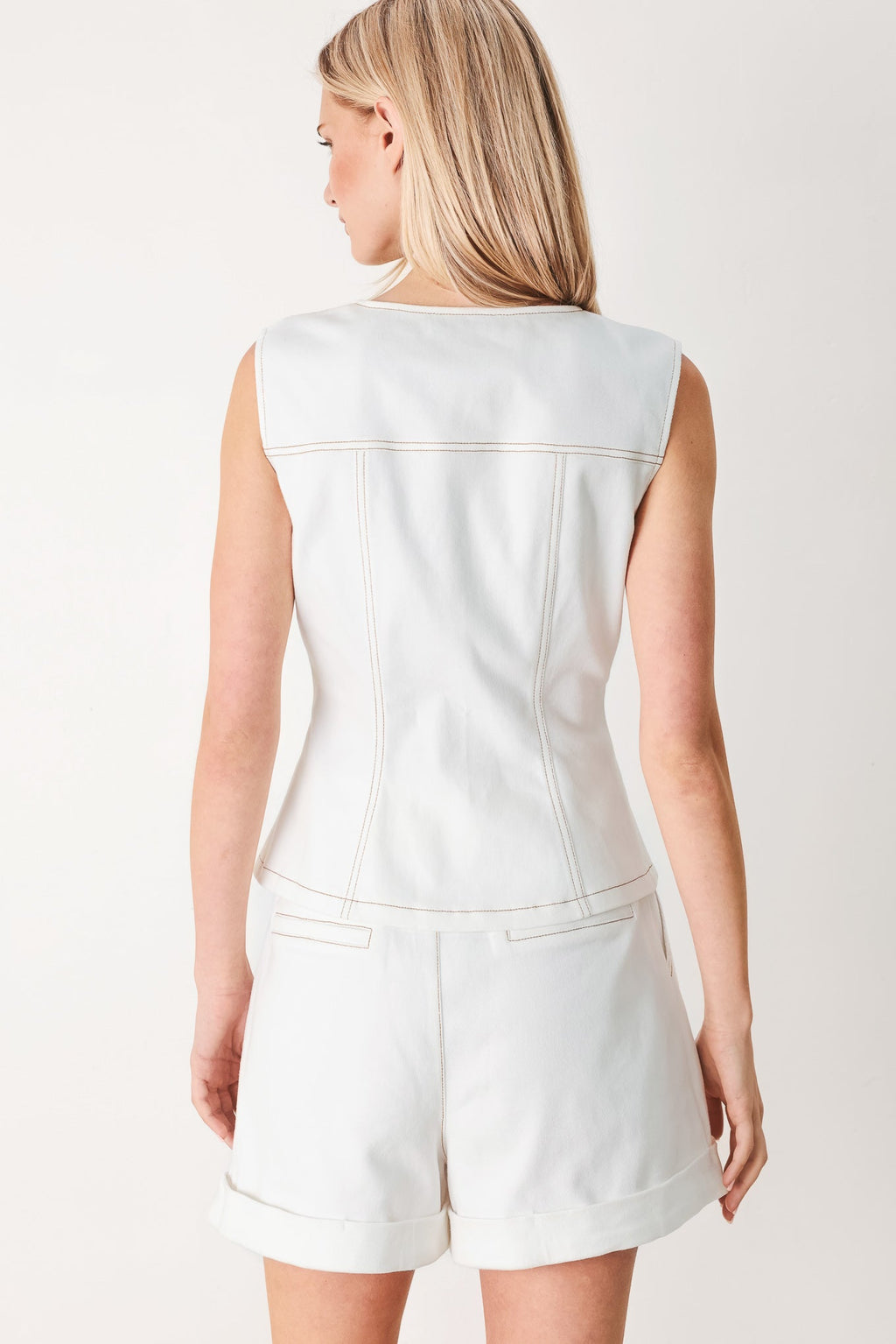 Better Together Woven Vest in White with round neckline, sleeveless cut, front closure, and pockets shown on model