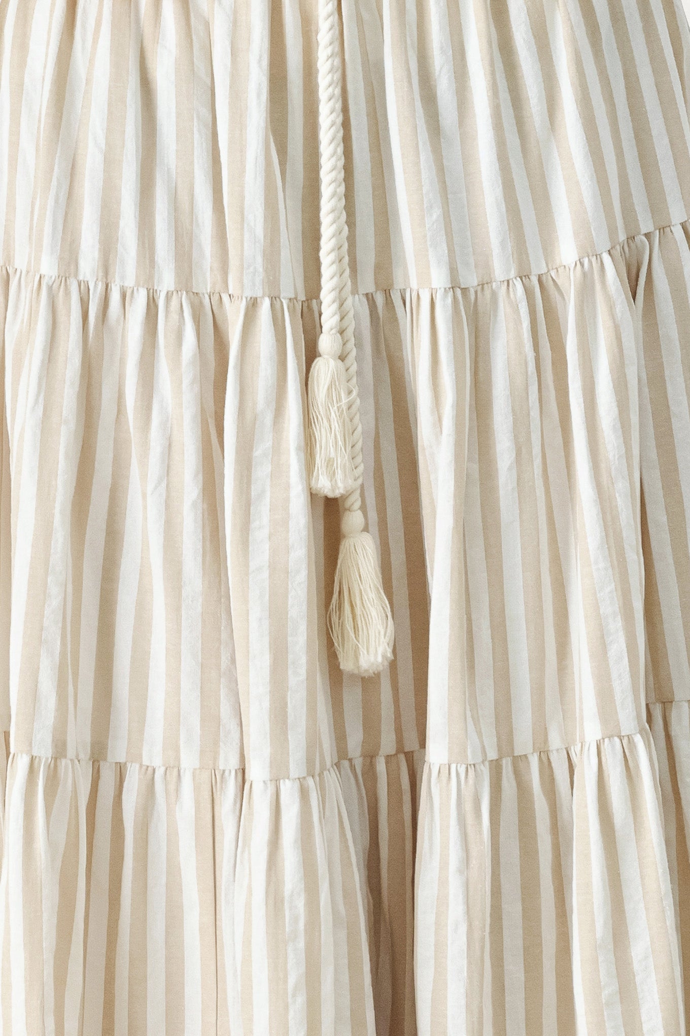 Hamptons Weekend Woven Maxi Skirt in Taupe White with stripe print, tiered layers, rope belt, and elastic back waistband shown on model