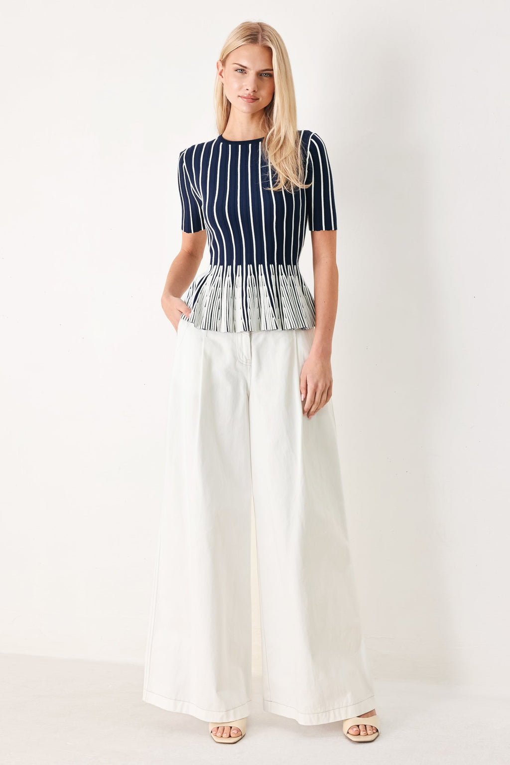 Easy Summer Stripe Sweater Knit Top in Navy White with round neckline, short sleeves, and peplum hem shown on model