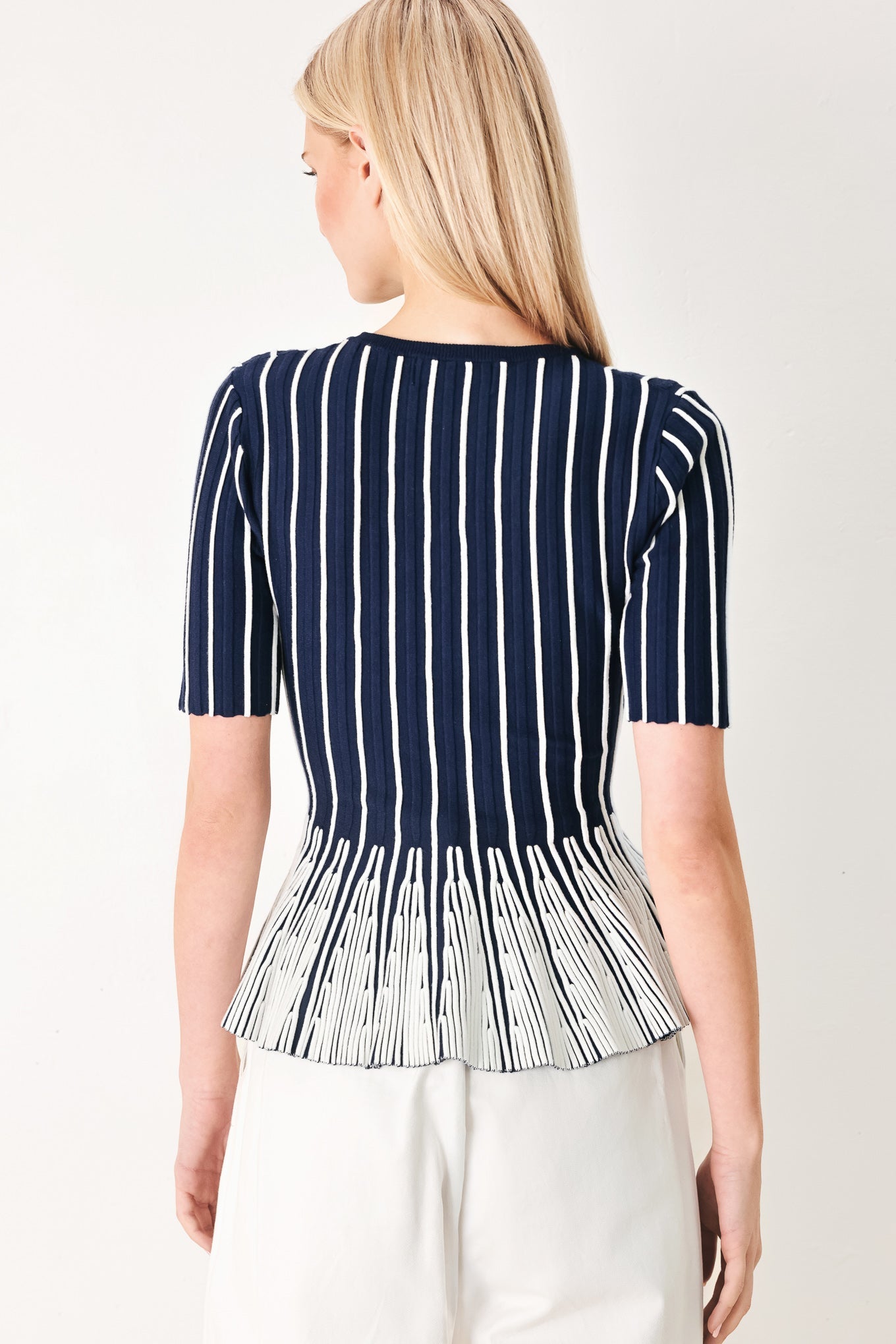 Easy Summer Stripe Sweater Knit Top in Navy White with round neckline, short sleeves, and peplum hem shown on model