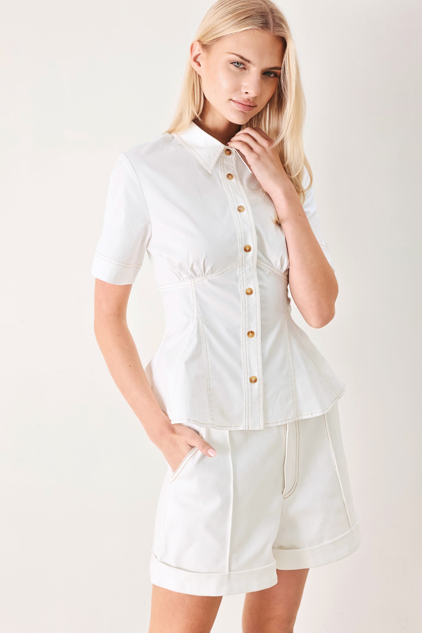 Made for Sunshine Woven Top in Off White with front button closure, short sleeves, and peplum hem shown on model