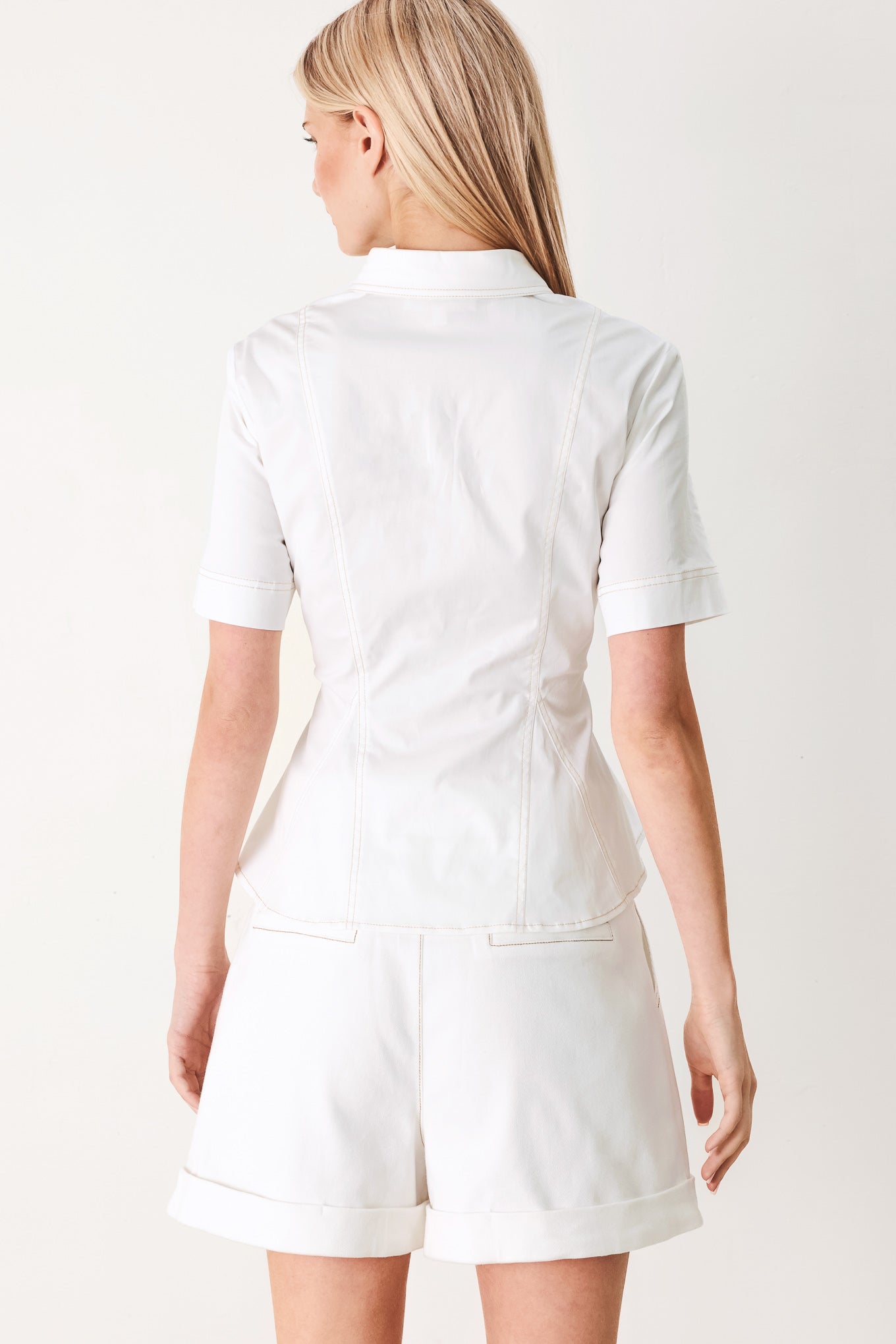 Made for Sunshine Woven Top in Off White with front button closure, short sleeves, and peplum hem shown on model