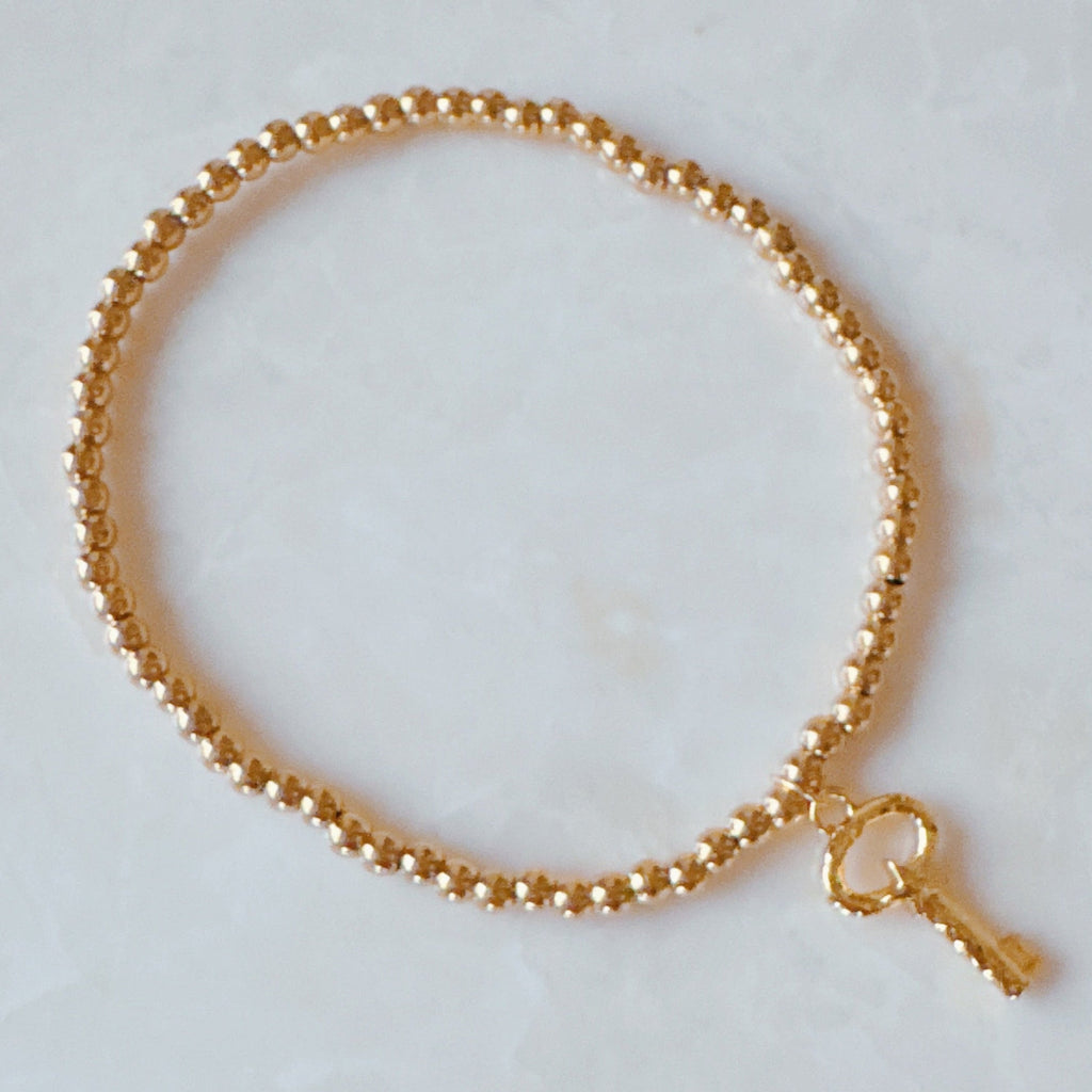 Golden Ball Single Charm Stretch Bracelet - Magic Key and Simply Cross charms