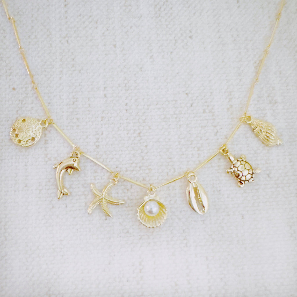 Golden Sea Charm Necklace - close up of ocean charms