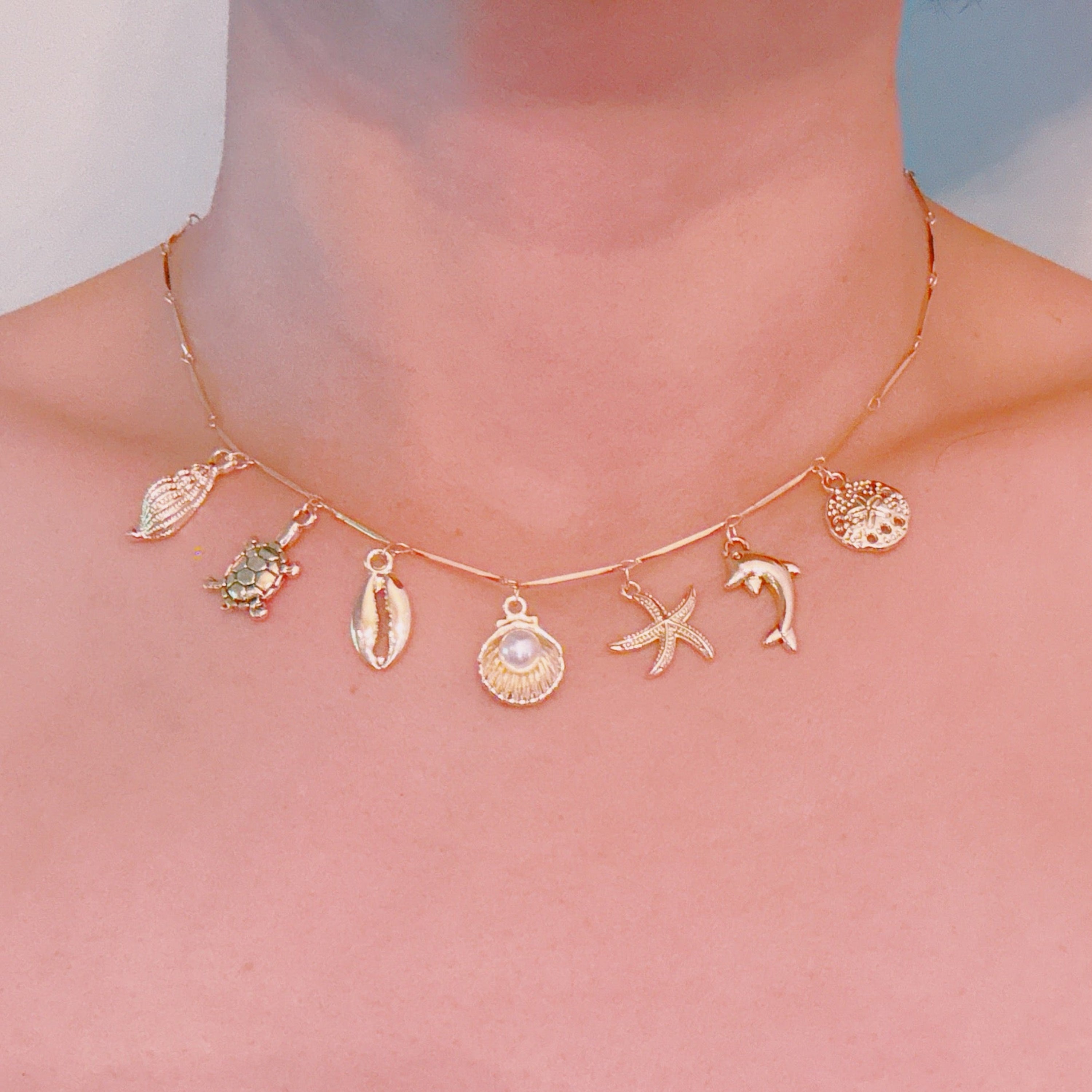Golden Sea Charm Necklace with shell dolphin and starfish charms