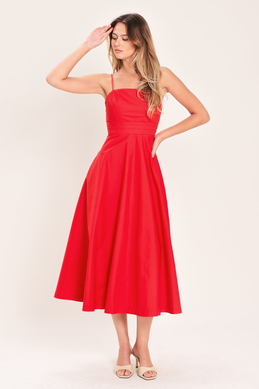 Modern Romance Woven Midi Dress in Red with straight neckline, straps, pleated waistband, circle skirt, and back zipper closure shown on model