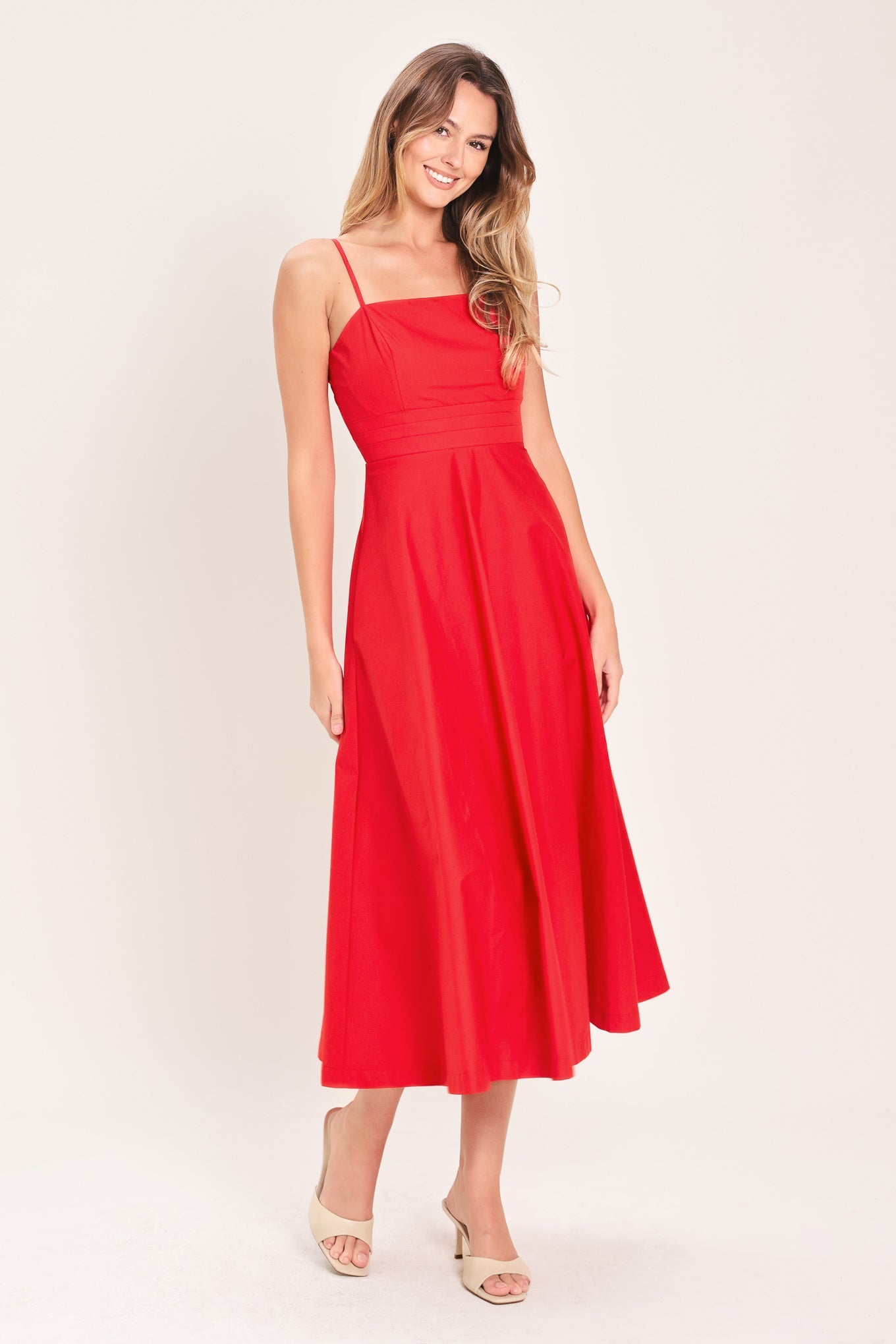 Modern Romance Woven Midi Dress in Red with straight neckline, straps, pleated waistband, circle skirt, and back zipper closure shown on model