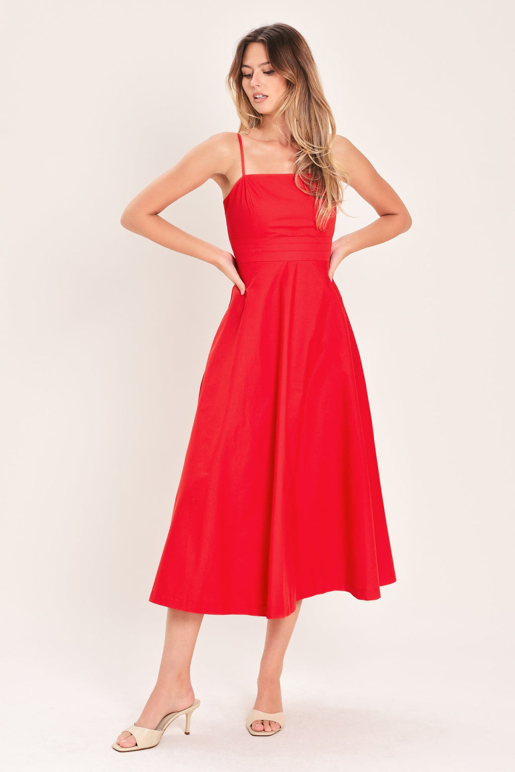 Modern Romance Woven Midi Dress in Red with straight neckline, straps, pleated waistband, circle skirt, and back zipper closure shown on model
