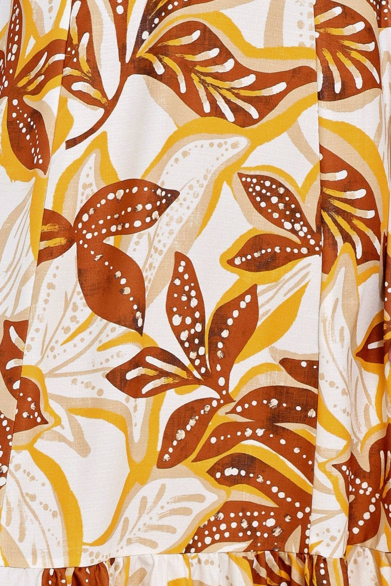 Amber Palm Paradise Woven Maxi Dress in Mustard Brown with palm print, halter tie neckline, ruffle hem, and back zipper closure shown on model