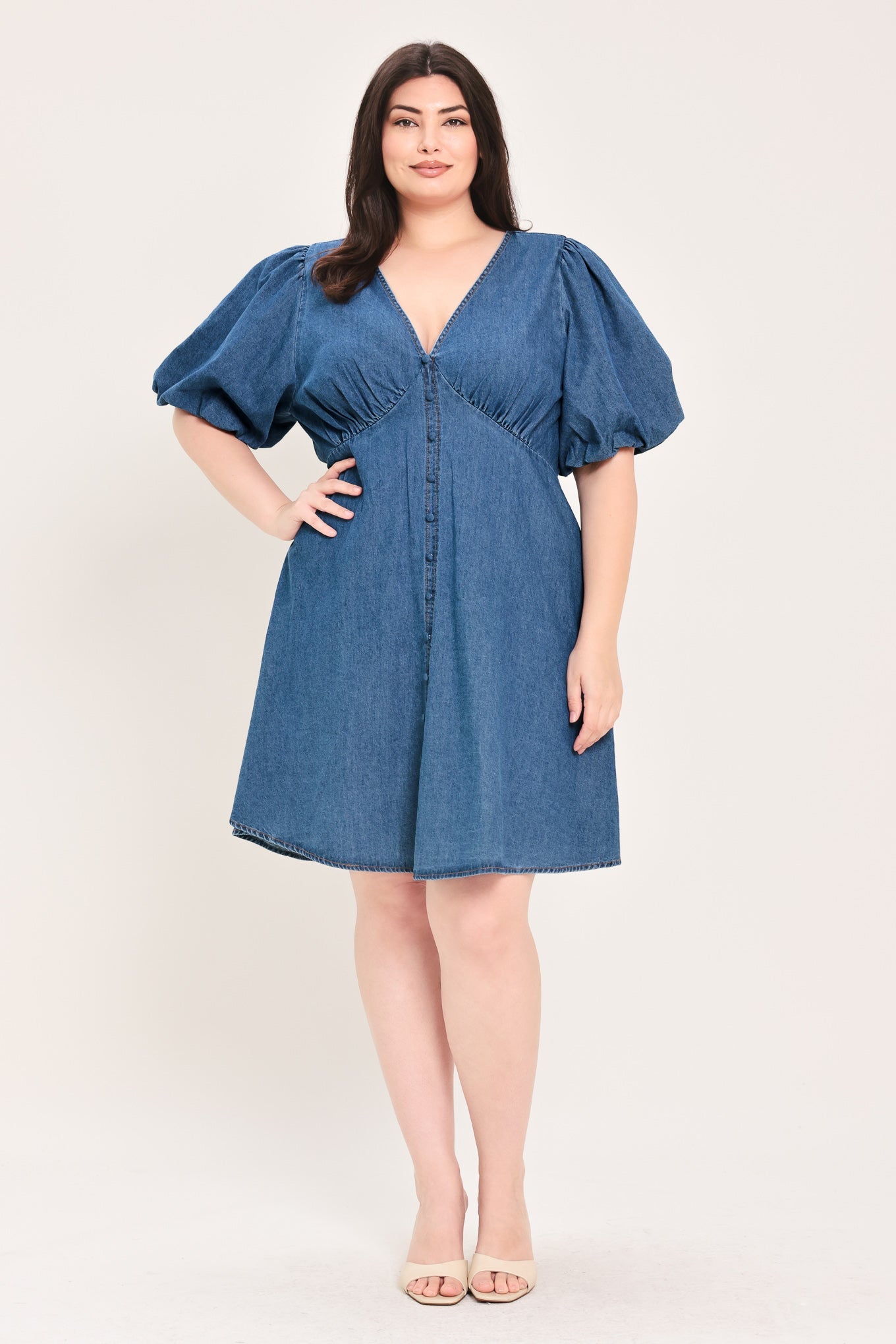 Soft Girl Denim Mini Dress in Medium Indigo Plus with V-neckline, puff sleeves, button-down detail, and circle skirt shown on model