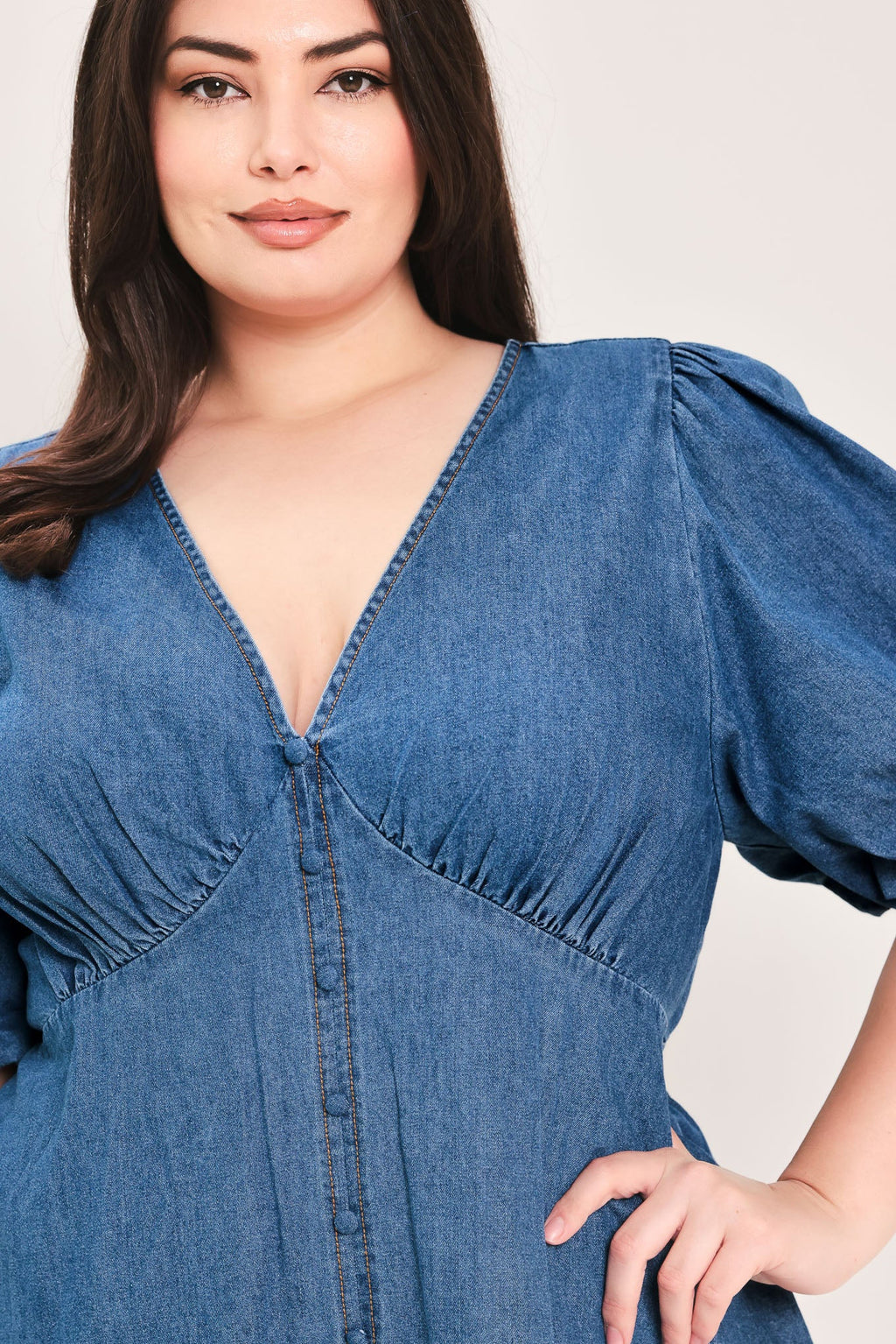 Soft Girl Denim Mini Dress in Medium Indigo Plus with V-neckline, puff sleeves, button-down detail, and circle skirt shown on model