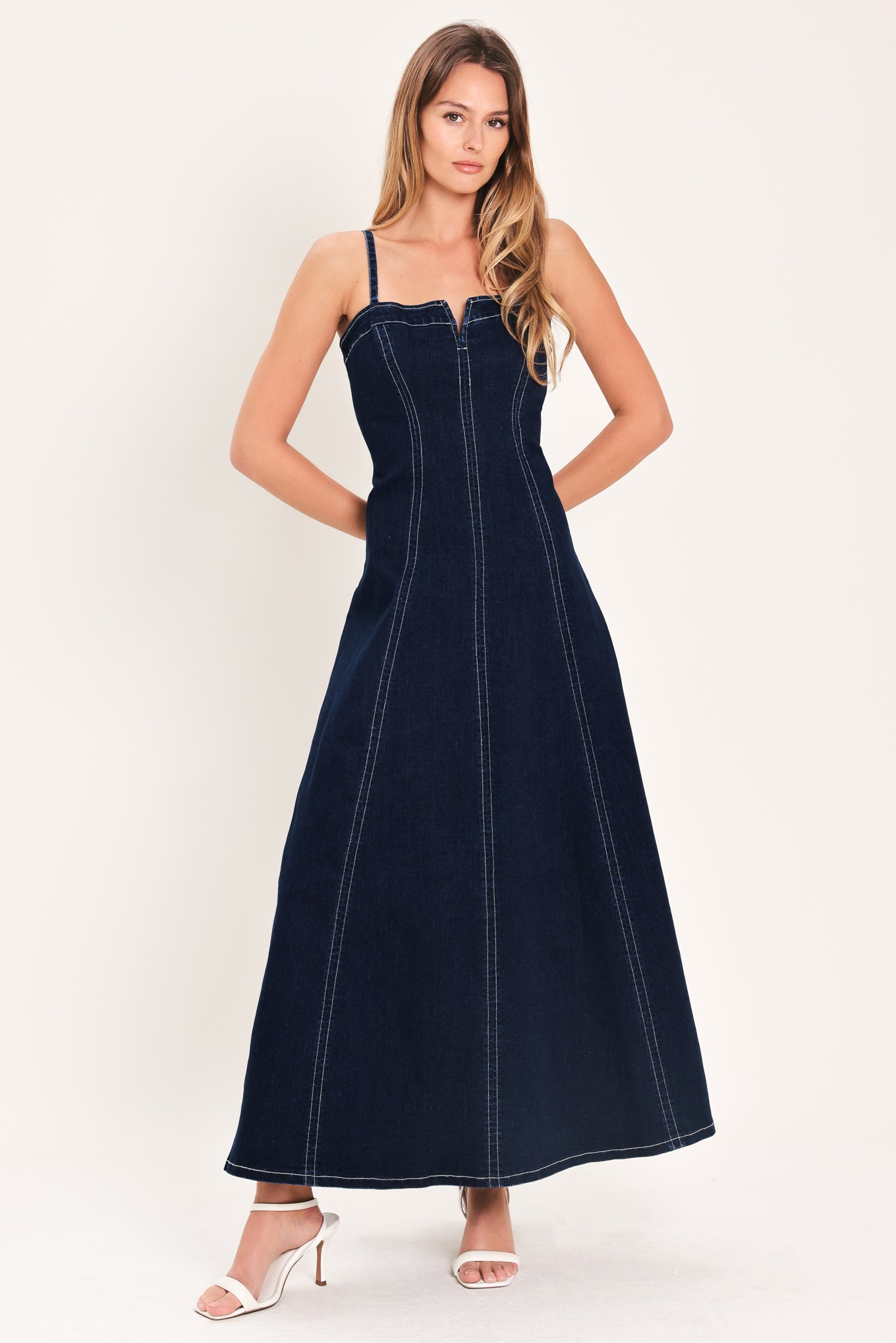 Denim Corset Midi Dress in Dark Indigo with straight neckline, V cut out, adjustable straps, circle skirt, and back zipper closure shown on model