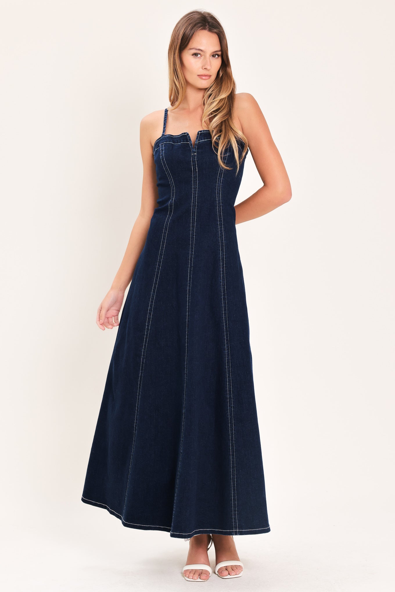 Denim Corset Midi Dress in Dark Indigo with straight neckline, V cut out, adjustable straps, circle skirt, and back zipper closure shown on model