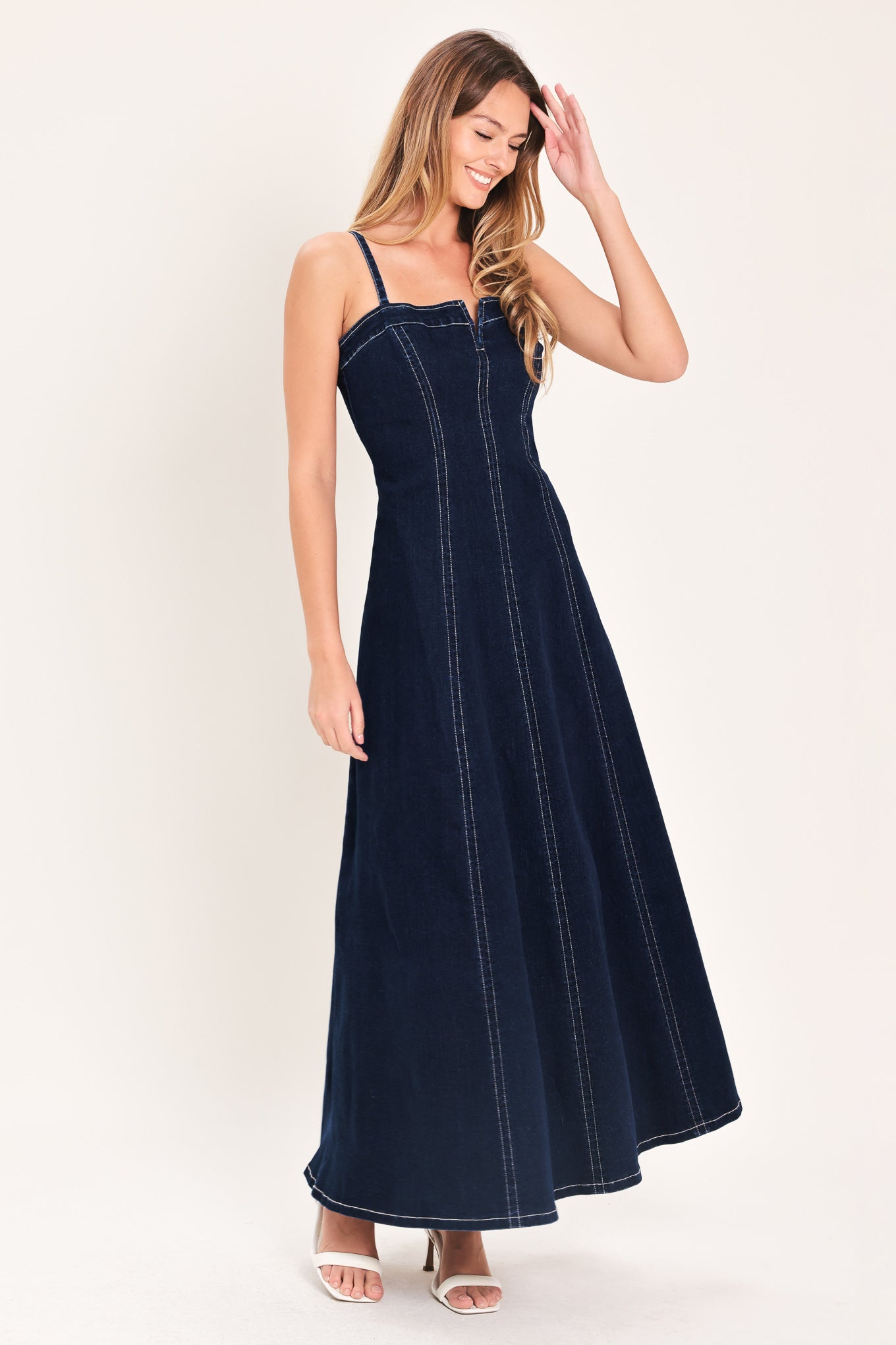 Denim Corset Midi Dress in Dark Indigo with straight neckline, V cut out, adjustable straps, circle skirt, and back zipper closure shown on model