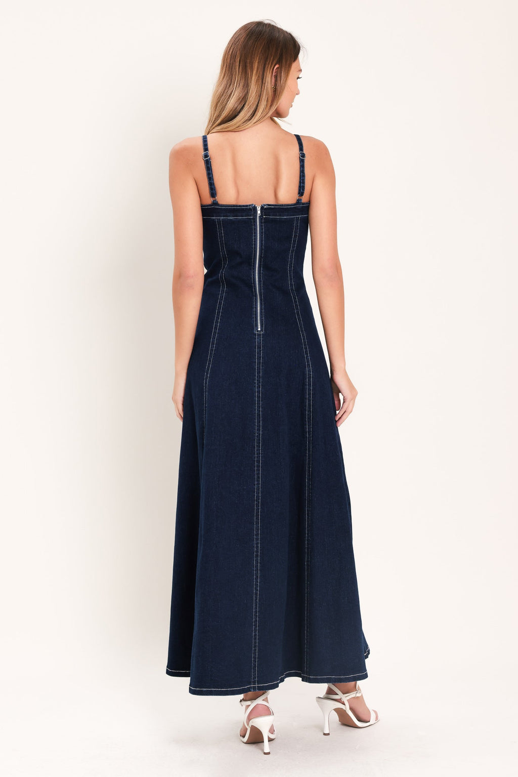 Denim Corset Midi Dress in Dark Indigo with straight neckline, V cut out, adjustable straps, circle skirt, and back zipper closure shown on model