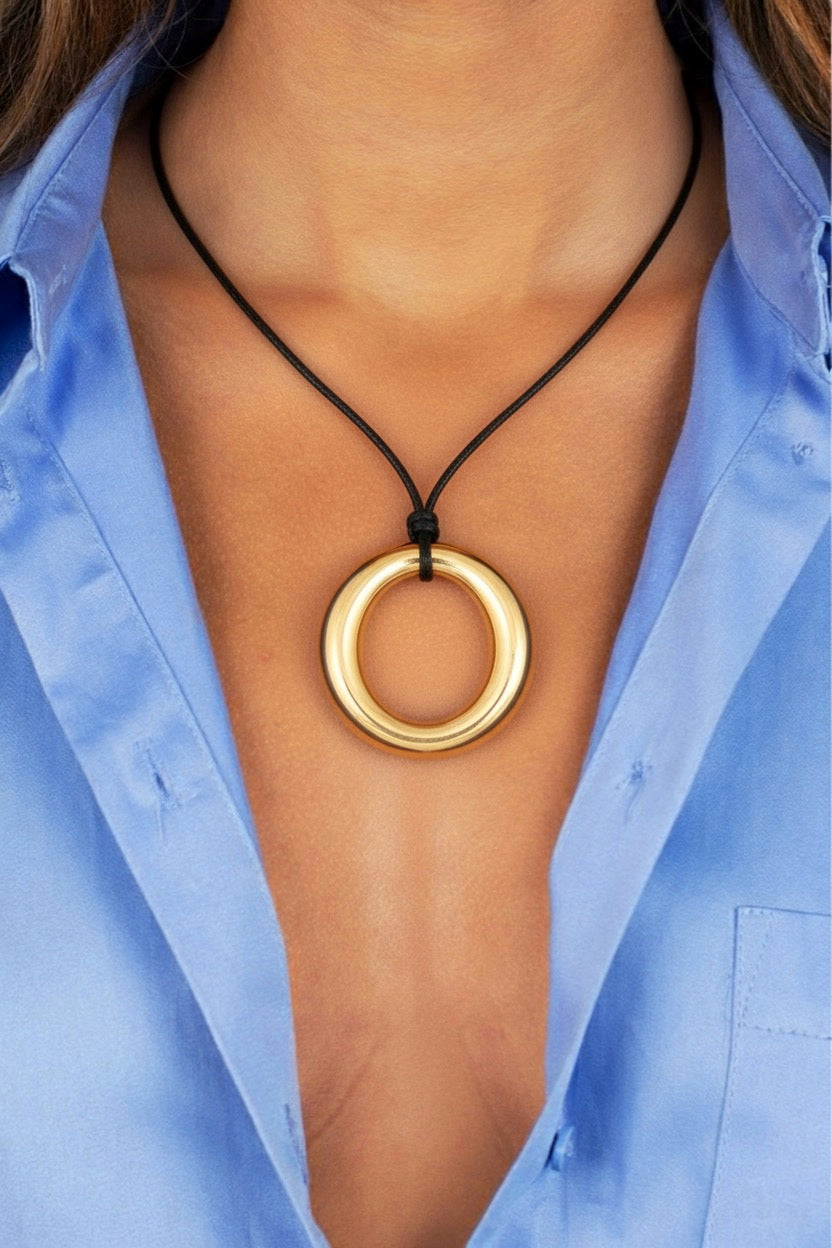 Sunline Necklace - close up of gold medallion detail