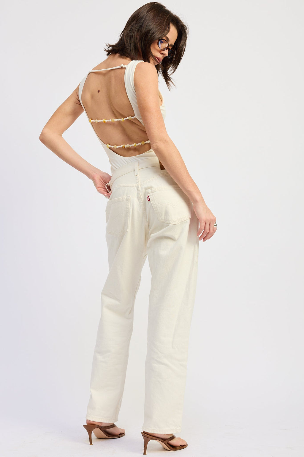 Solara Bodysuit in Off-White - styled tucked into denim