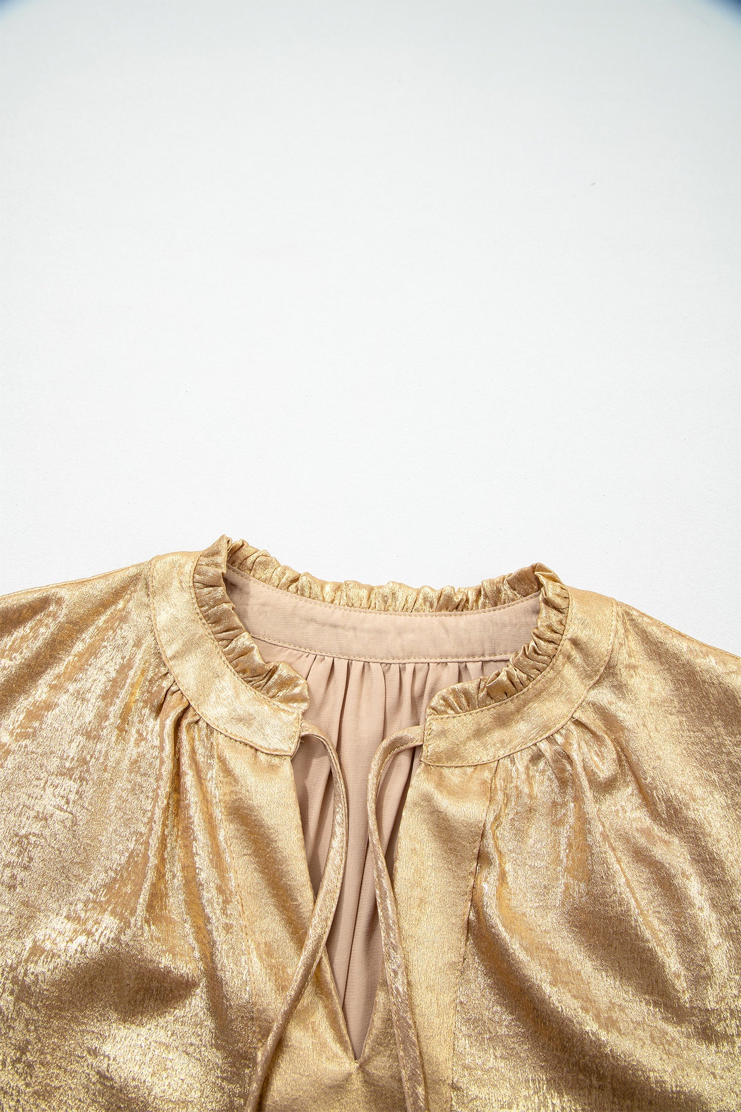 Gold metallic blouse fabric texture detail