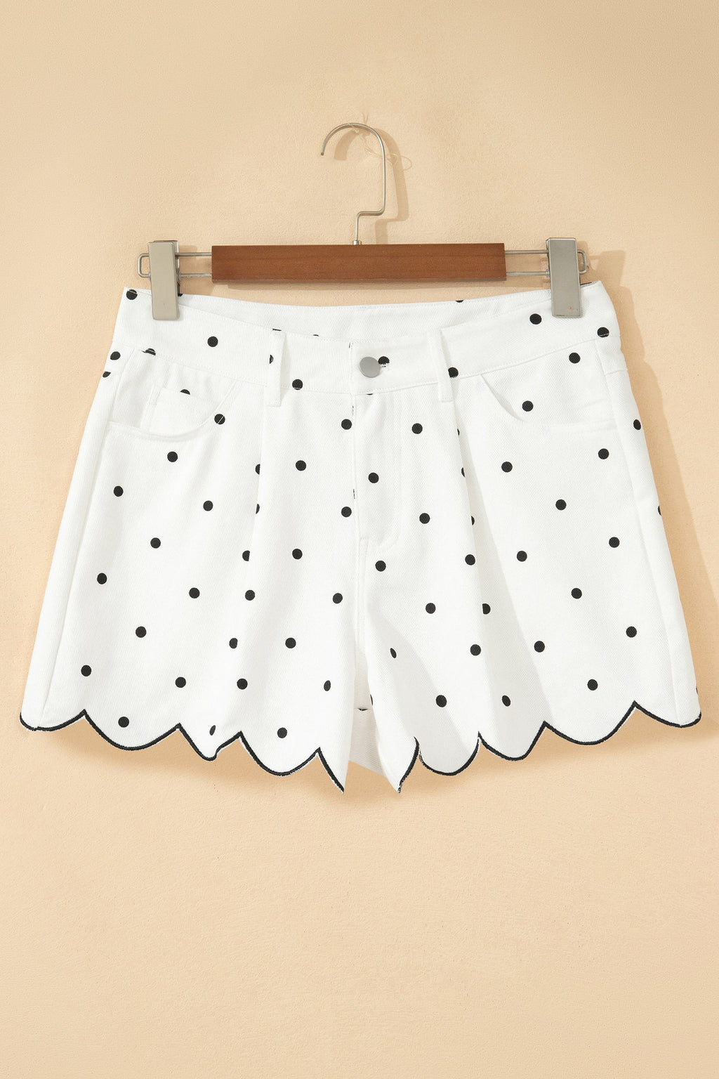 White polka dot denim shorts detail showing embroidered scallop hem trim