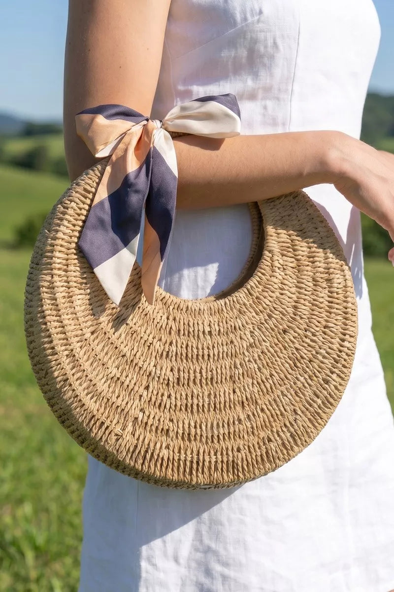 Fame Round Woven Straw Bag With Bow Scarf Accent - front view showing circular straw silhouette and fabric bow scarf