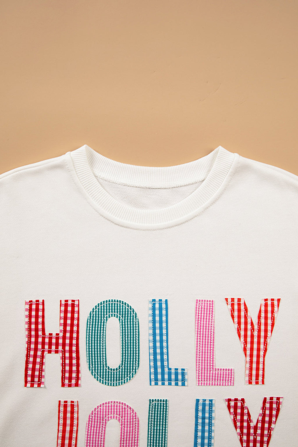Christmas Holly Jolly Patchwork Sweatshirt in white, close-up