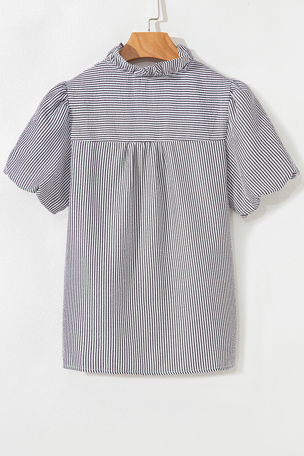 Black striped shirt ruffled collar close-up